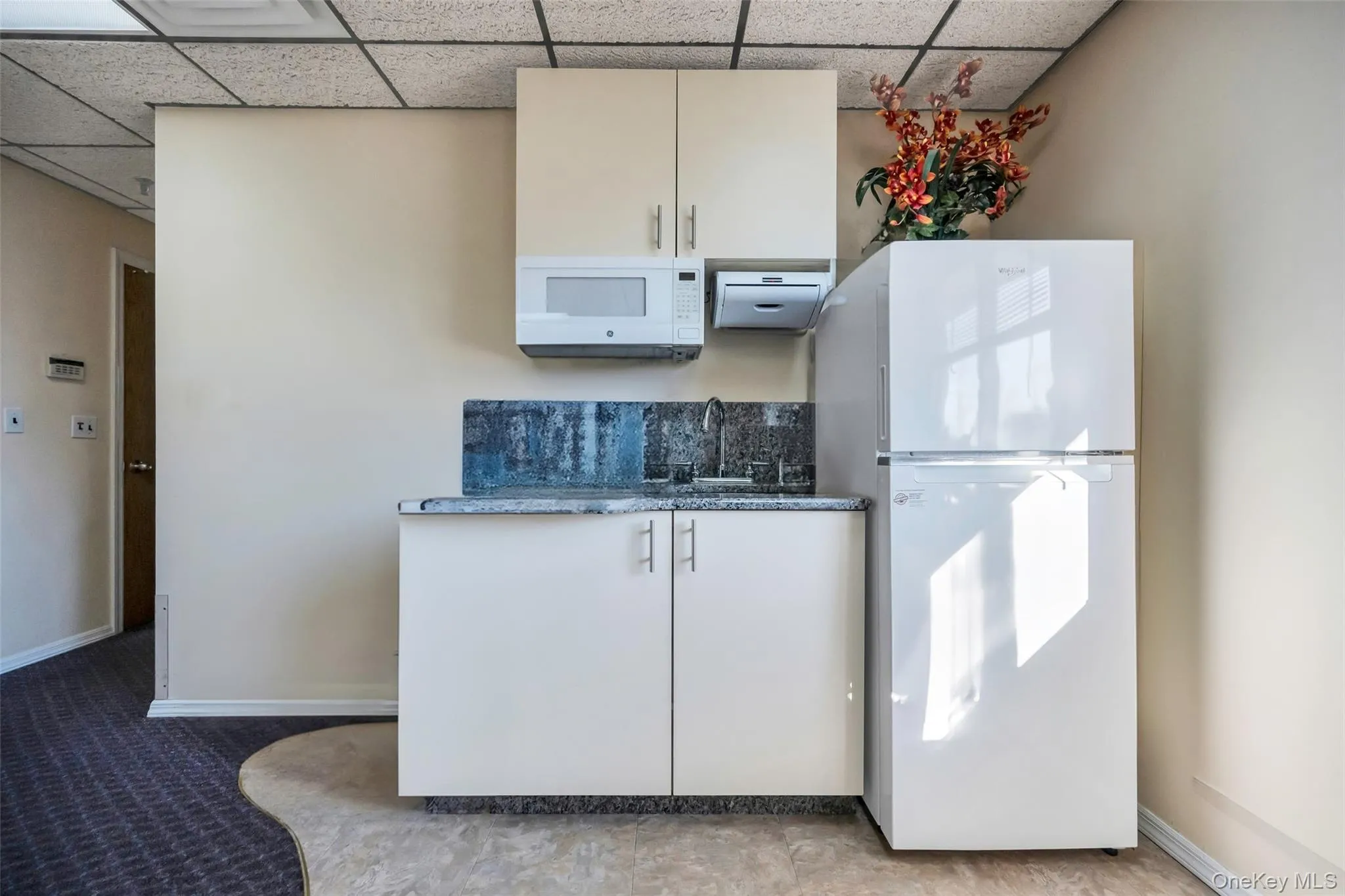 Kitchen featuring white appliances and sink Kitchen featuring white appliances and sink