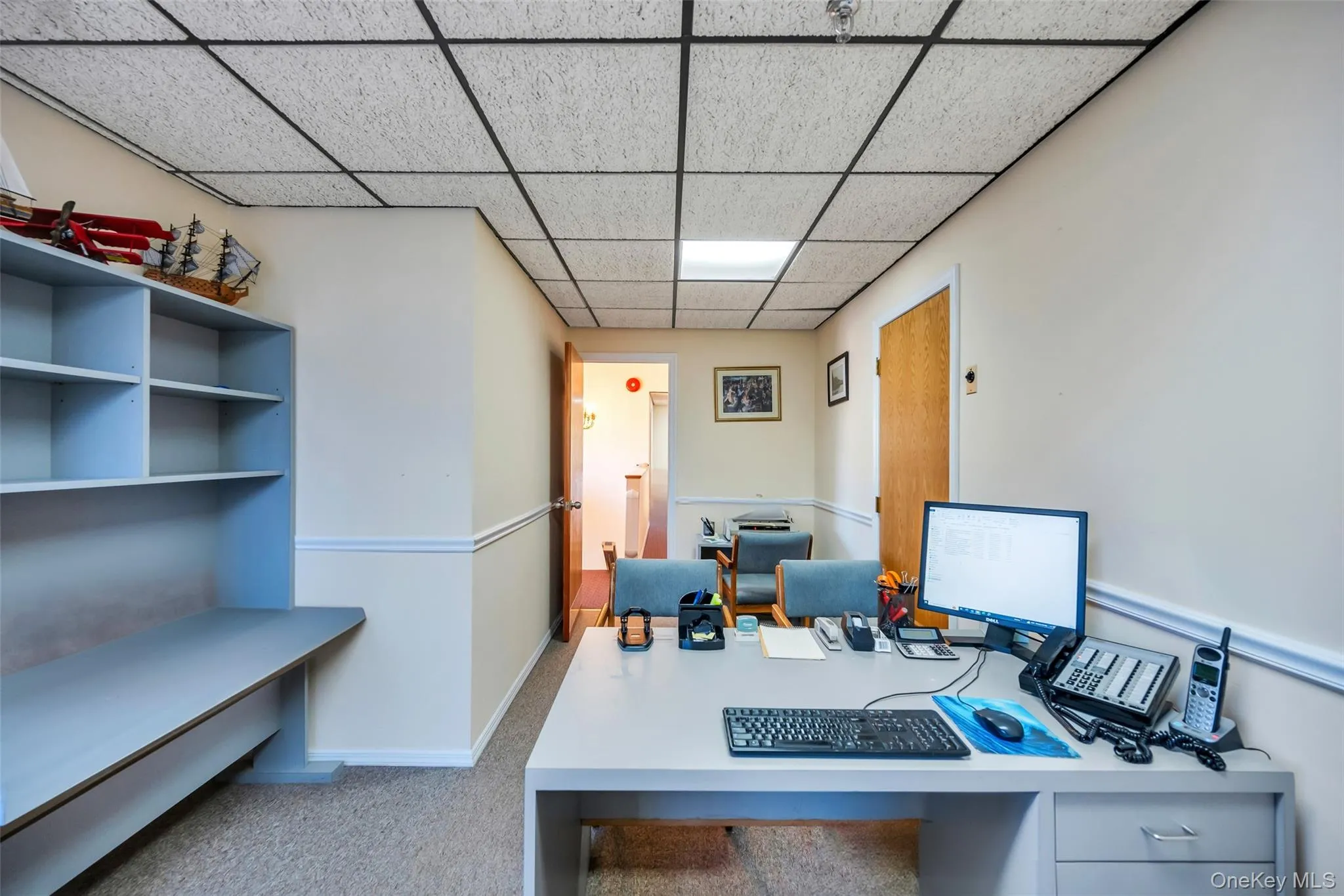 Carpeted home office with a drop ceiling Carpeted home office with a drop ceiling