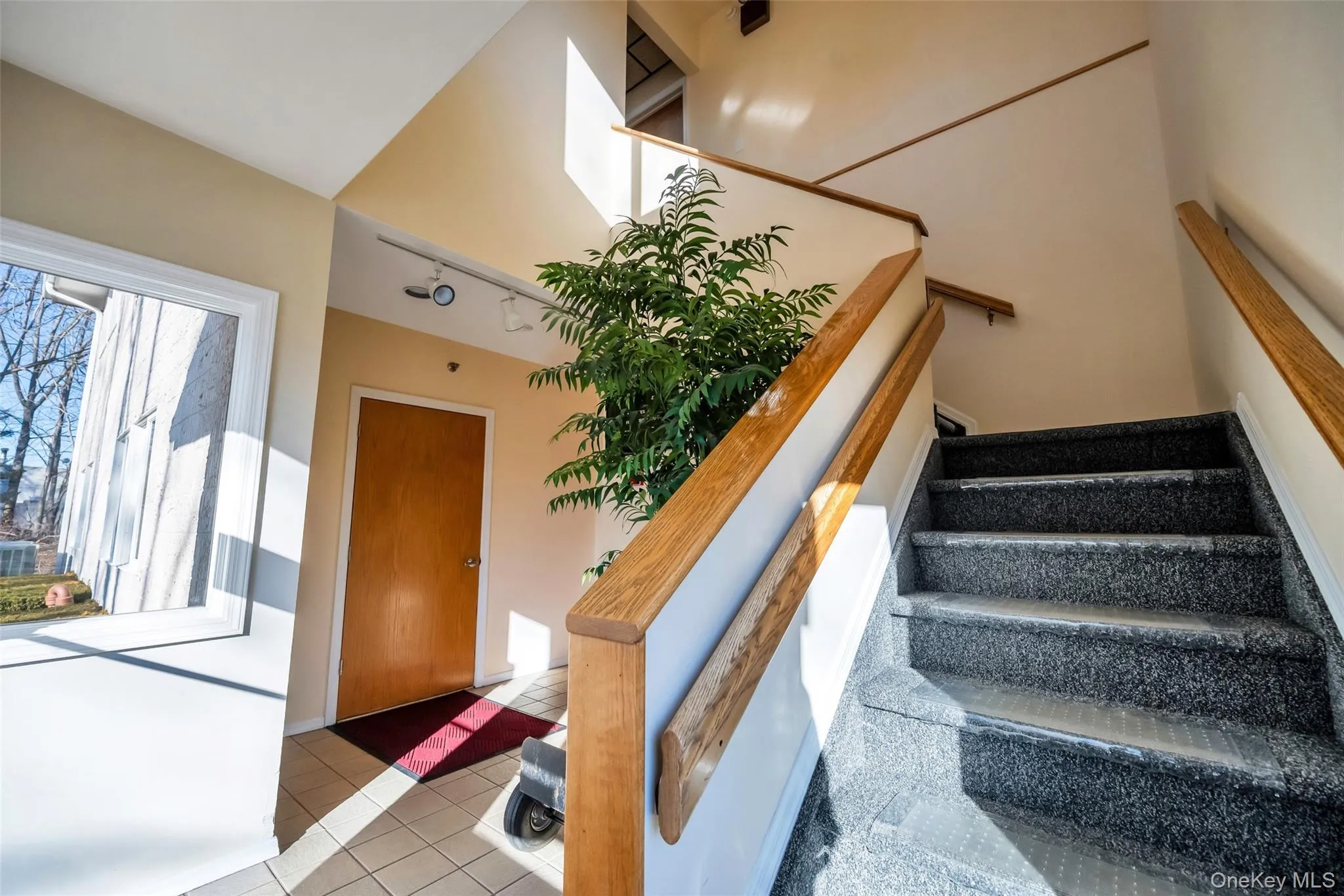 Stairs featuring track lighting and tile patterned flooring Stairs featuring track lighting and tile patterned flooring