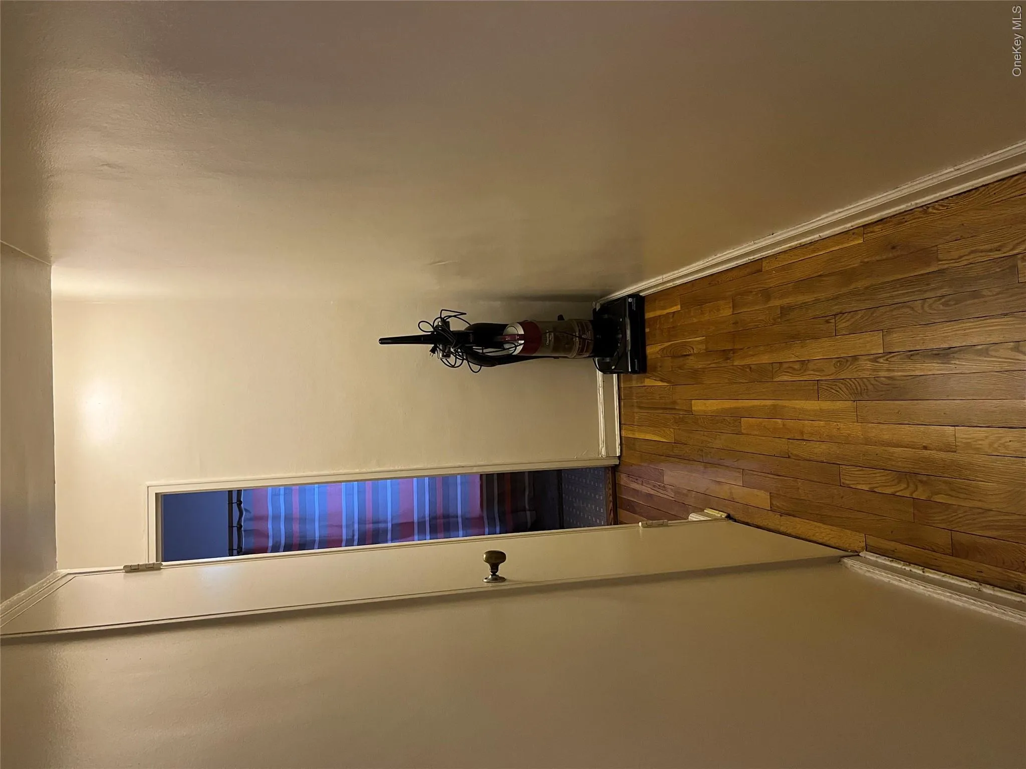 Corridor with dark hardwood / wood-style flooring Corridor with dark hardwood / wood-style flooring