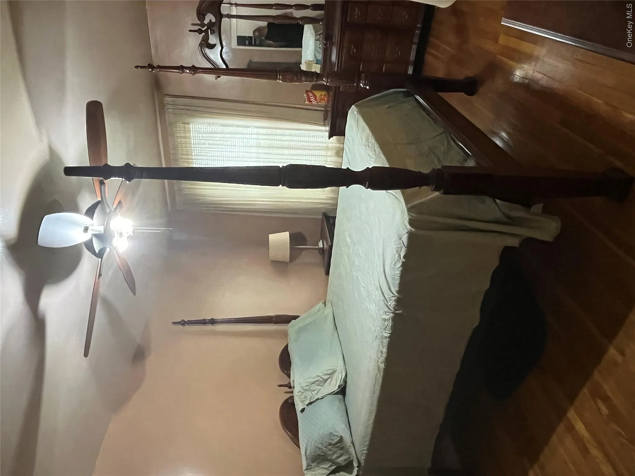 Bedroom featuring dark wood-type flooring and ceiling fan Bedroom featuring dark wood-type flooring and ceiling fan