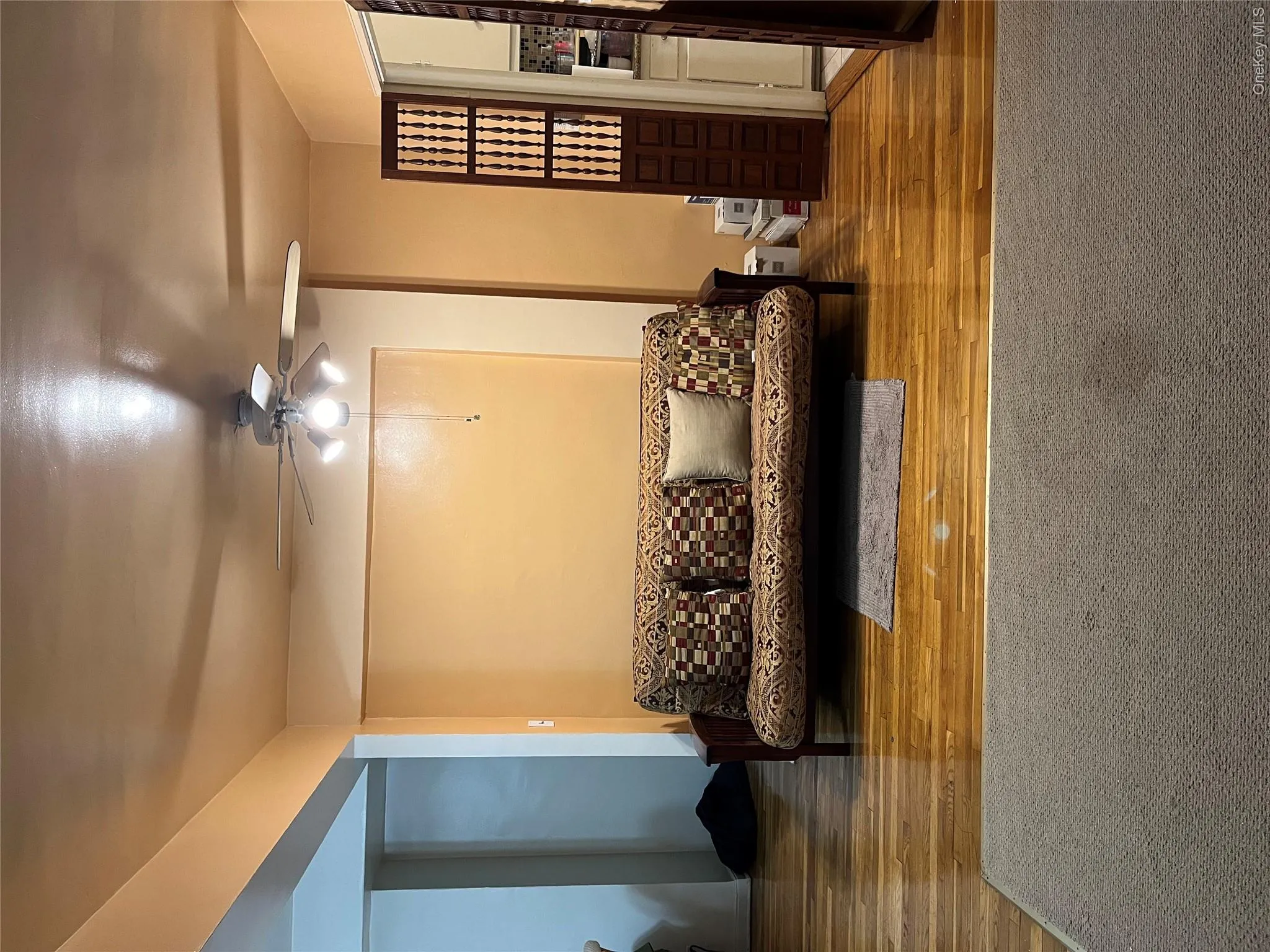 Living room with ceiling fan and hardwood / wood-style flooring Living room with ceiling fan and hardwood / wood-style flooring