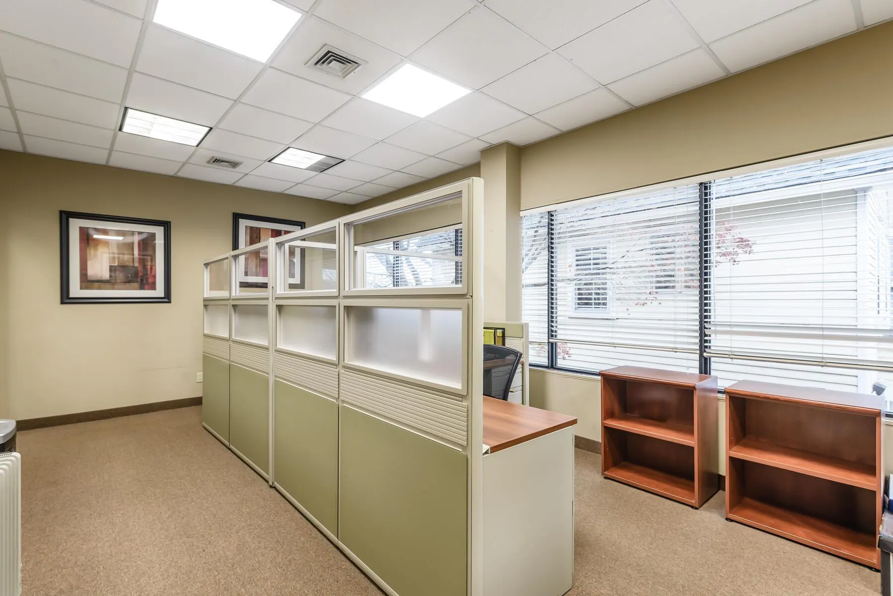 Office space featuring a paneled ceiling and light carpet Office space featuring a paneled ceiling and light carpet