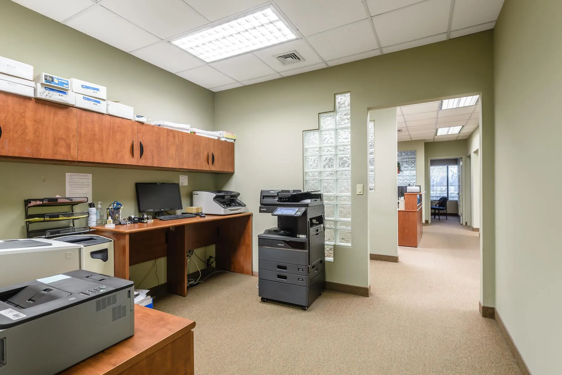 Carpeted office featuring a drop ceiling Carpeted office featuring a drop ceiling
