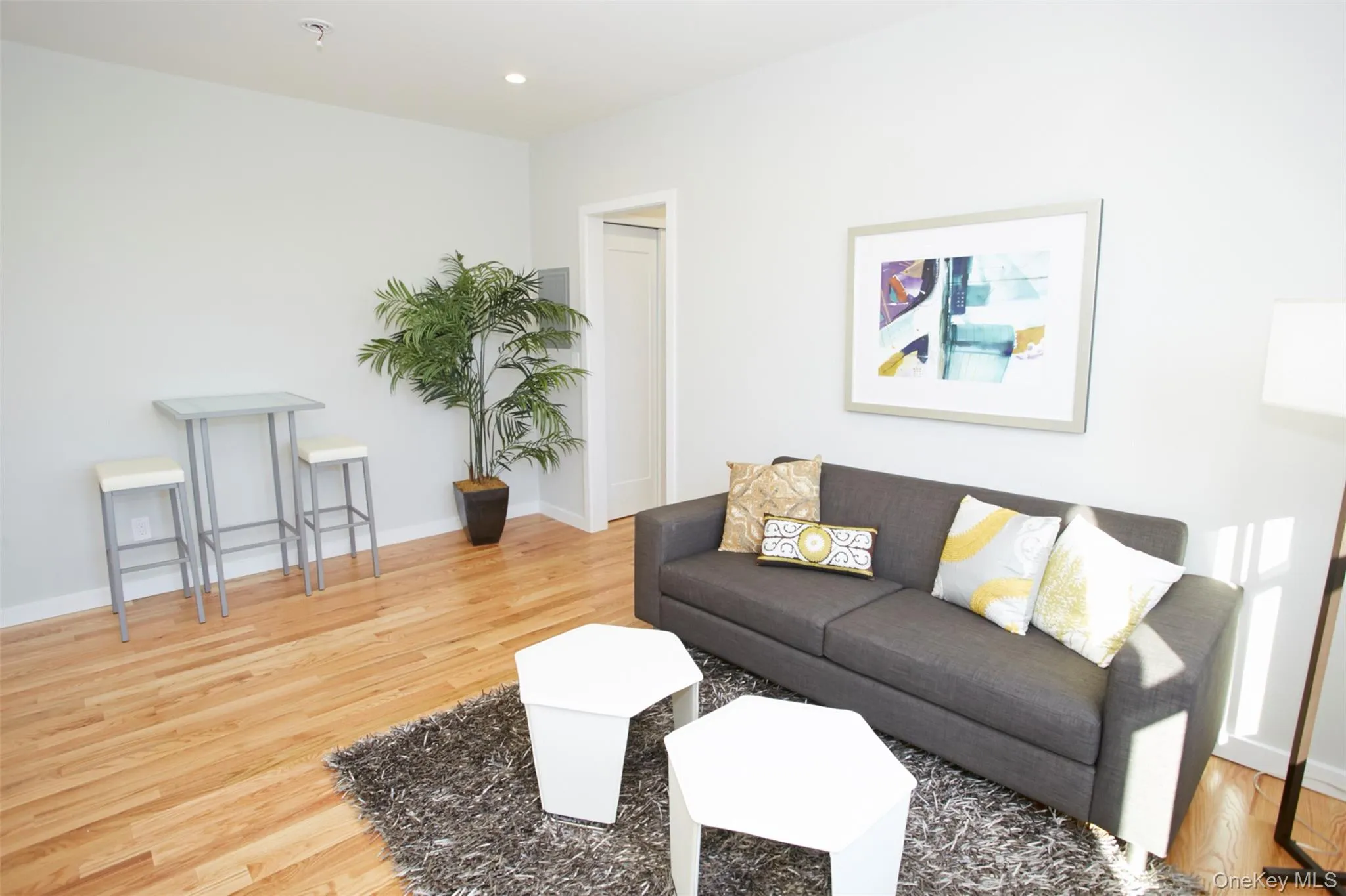Living room featuring light wood-style floors and recessed lighting Living room featuring light wood-style floors and recessed lighting