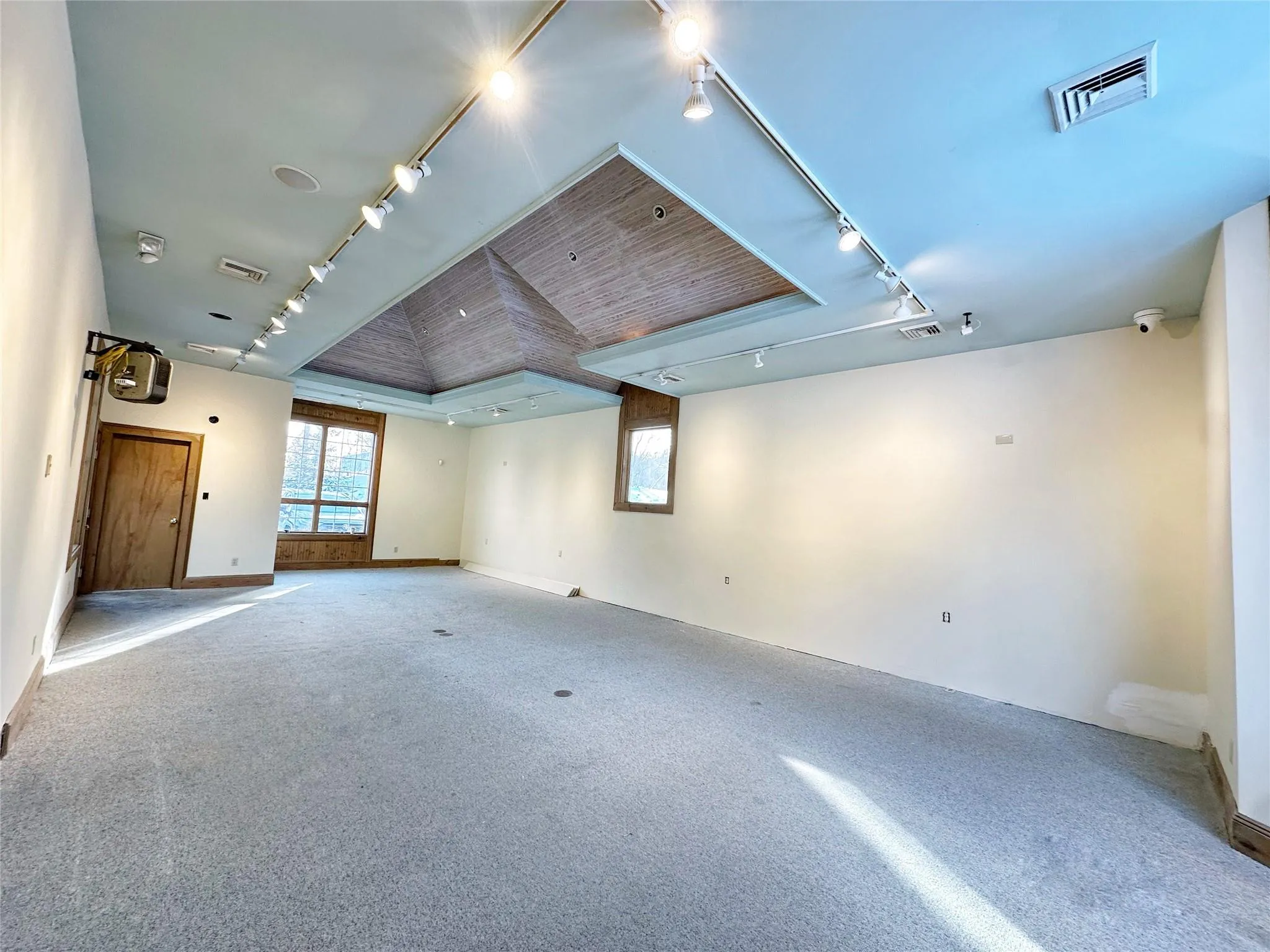 Carpeted empty room featuring a raised ceiling Carpeted empty room featuring a raised ceiling