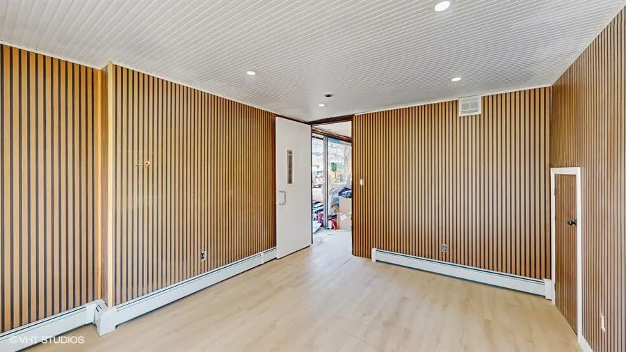 Spare room with visible vents, wood finished floors, a baseboard heating unit, and recessed lighting Spare room with visible vents, wood finished floors, a baseboard heating unit, and recessed lighting