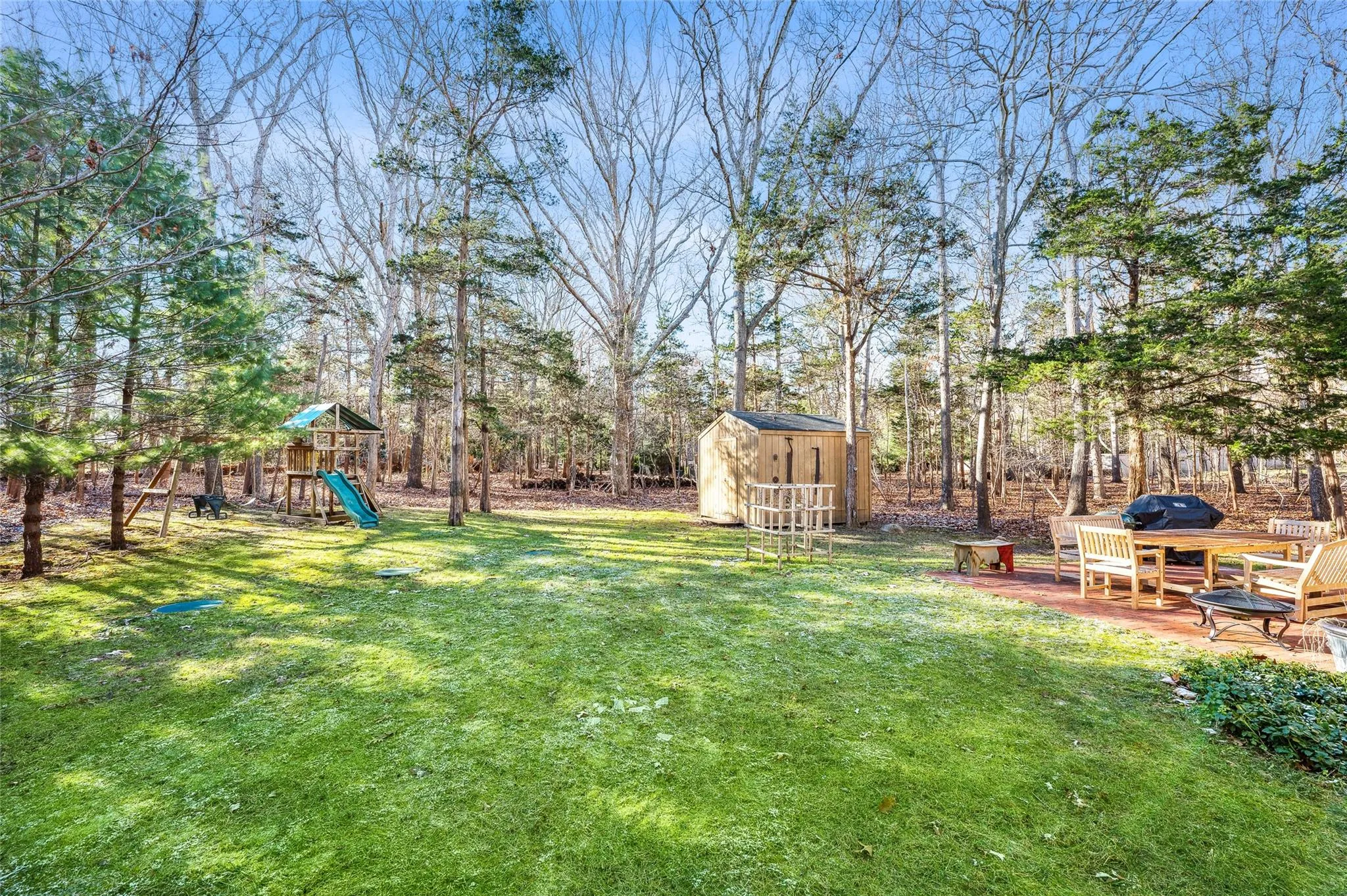 View of yard with a playground and a storage shed View of yard with a playground and a storage shed