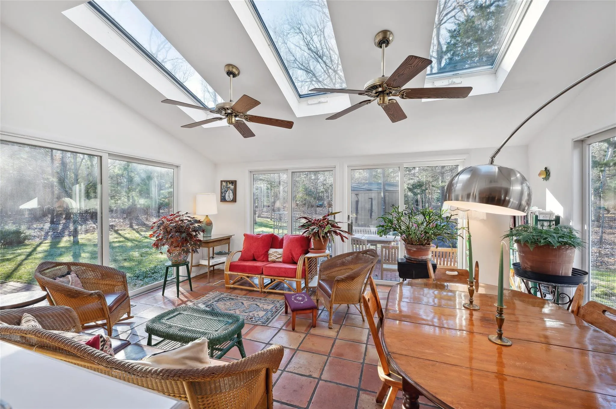 Sunroom featuring ceiling fan, vaulted ceiling with skylight, and plenty of natural light Sunroom featuring ceiling fan, vaulted ceiling with skylight, and plenty of natural light