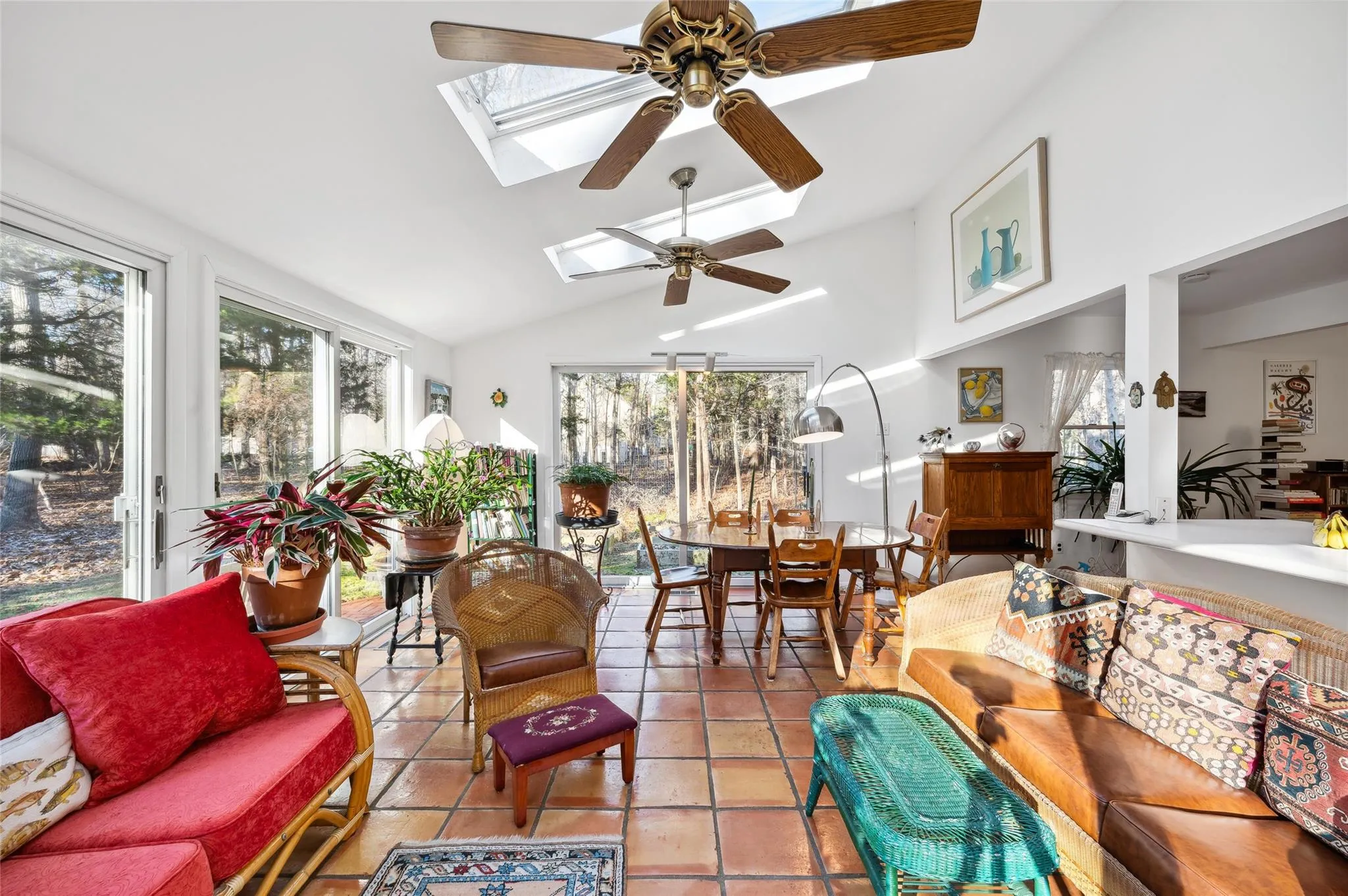 Sunroom / solarium with ceiling fan and lofted ceiling with skylight Sunroom / solarium with ceiling fan and lofted ceiling with skylight