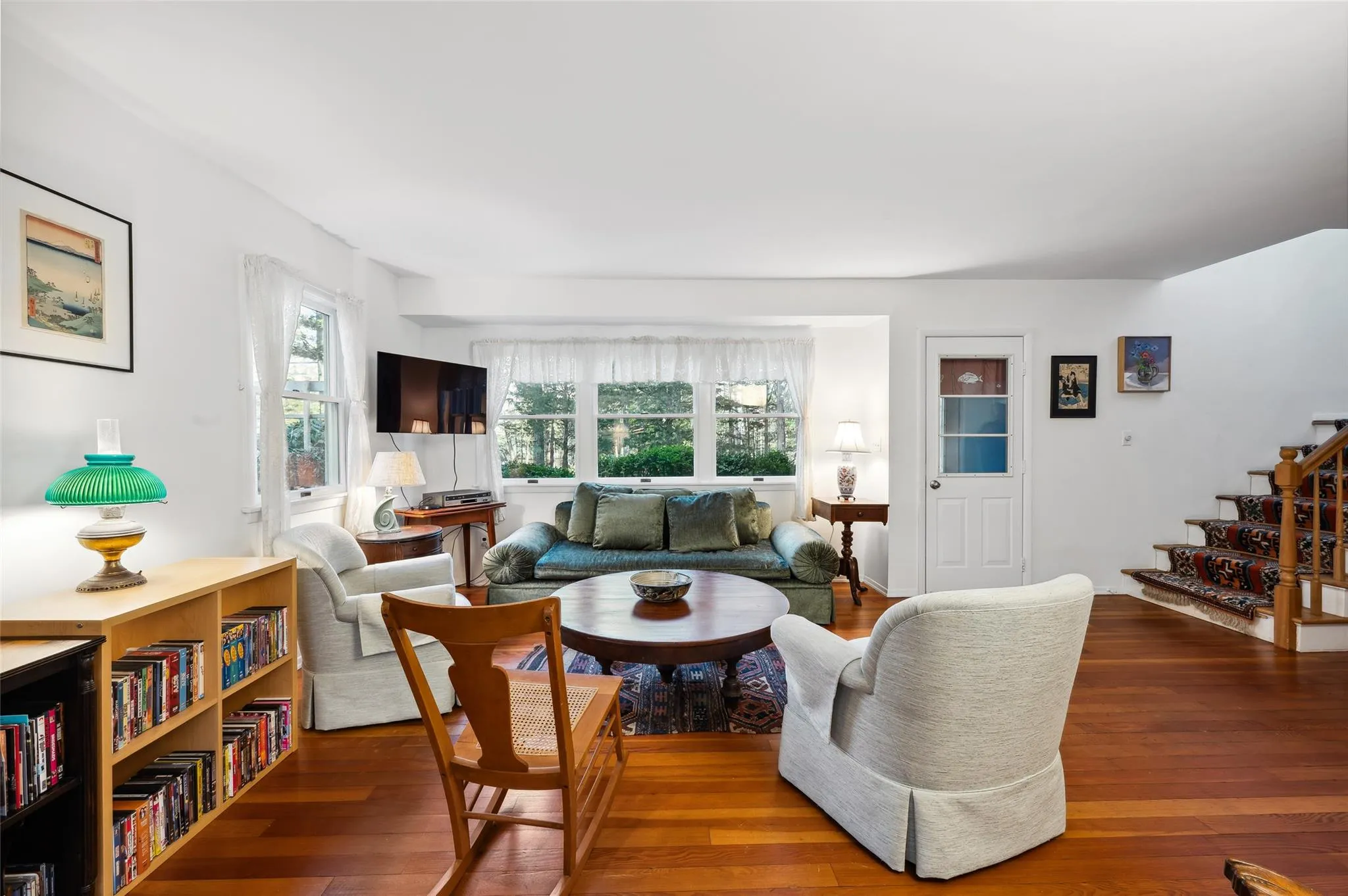 Living room with plenty of natural light and wood-type flooring Living room with plenty of natural light and wood-type flooring