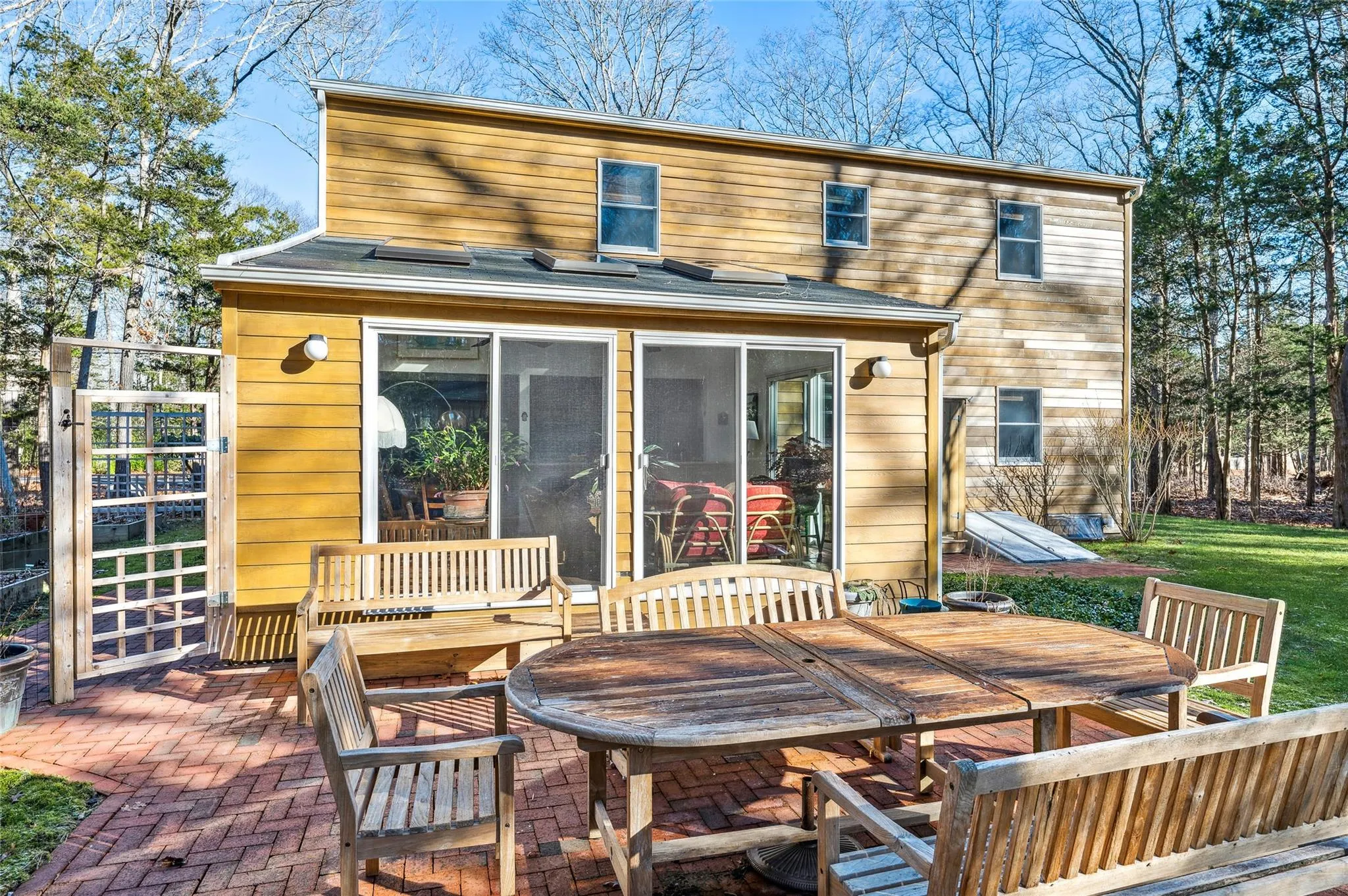 Back of house with a patio and a sunroom Back of house with a patio and a sunroom