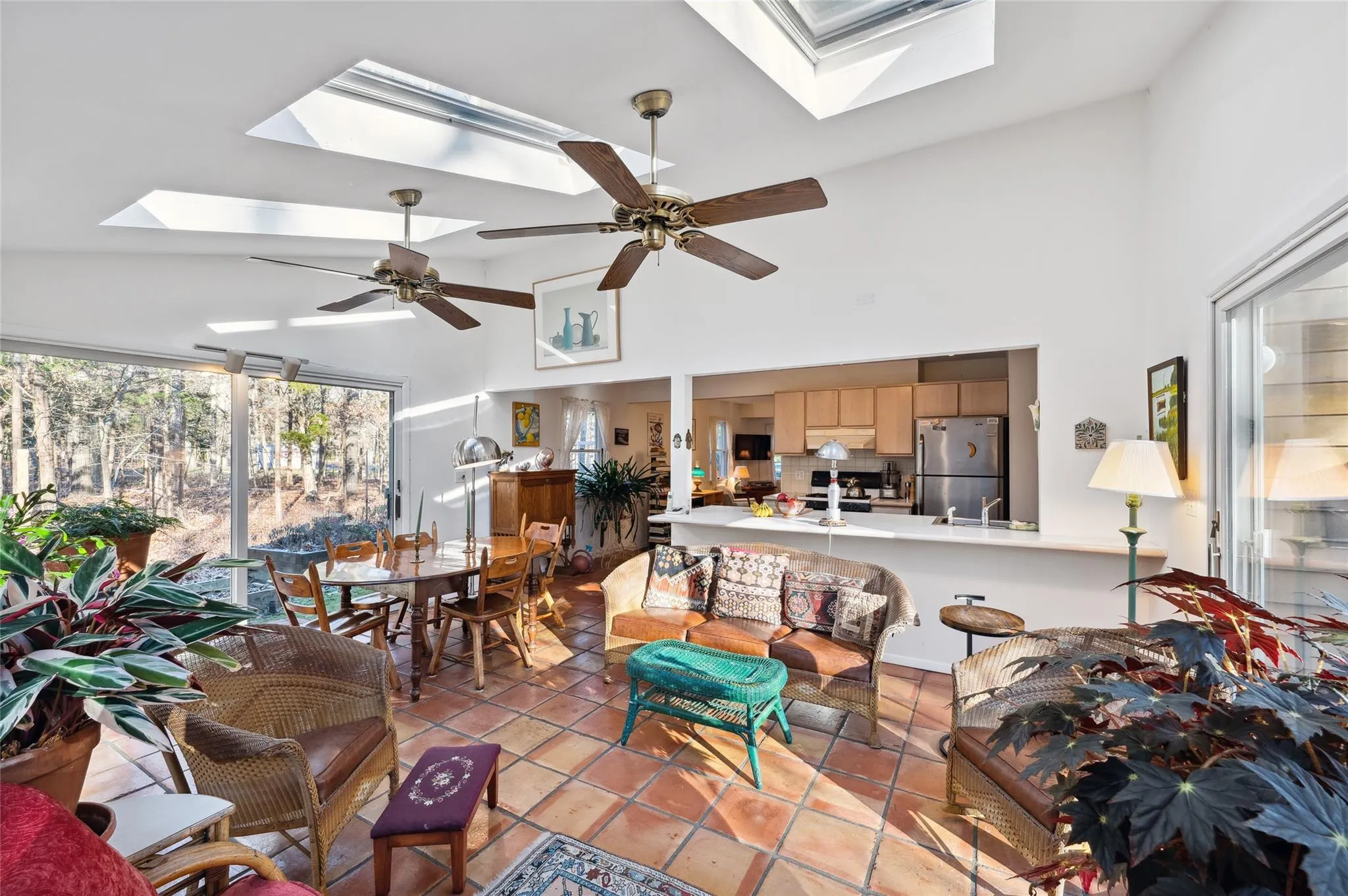 Tiled living room featuring high vaulted ceiling, sink, and a skylight Tiled living room featuring high vaulted ceiling, sink, and a skylight