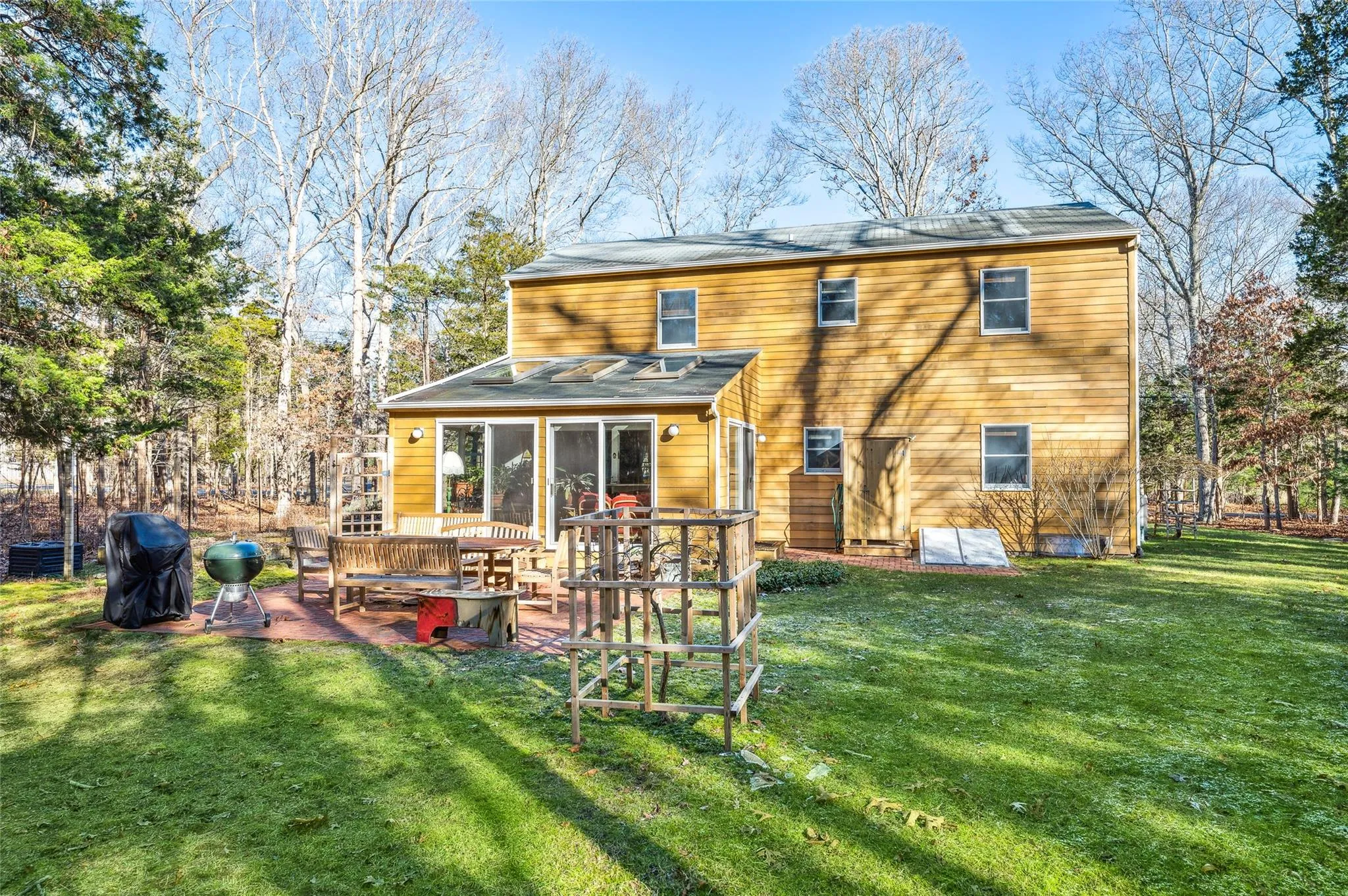 Rear view of house featuring cooling unit and a yard Rear view of house featuring cooling unit and a yard
