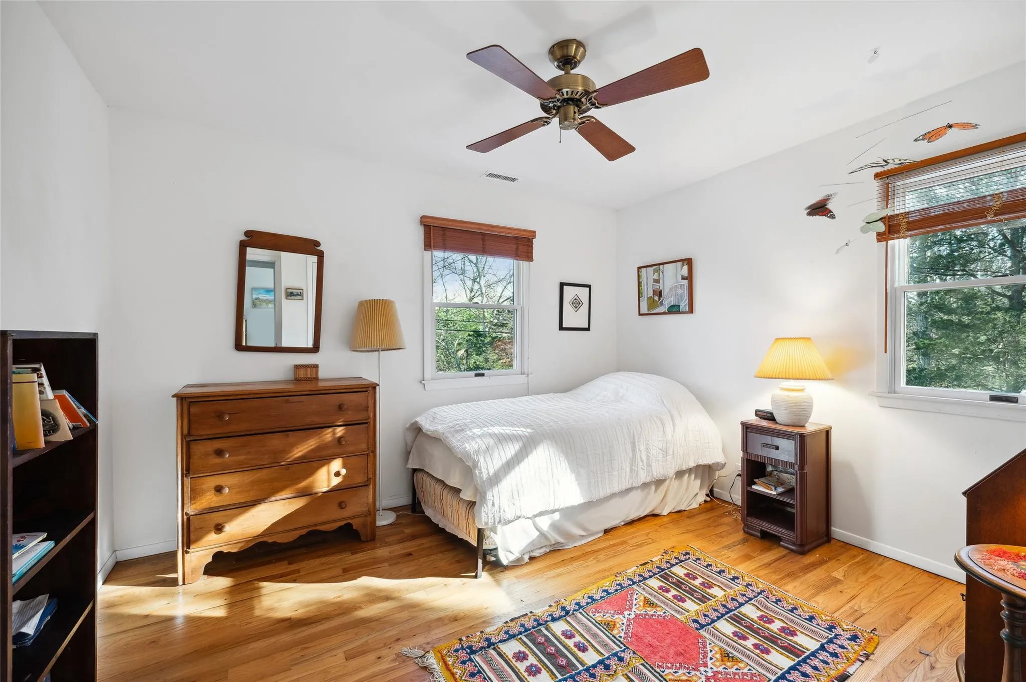 Bedroom featuring ceiling fan and light wood-type flooring Bedroom featuring ceiling fan and light wood-type flooring