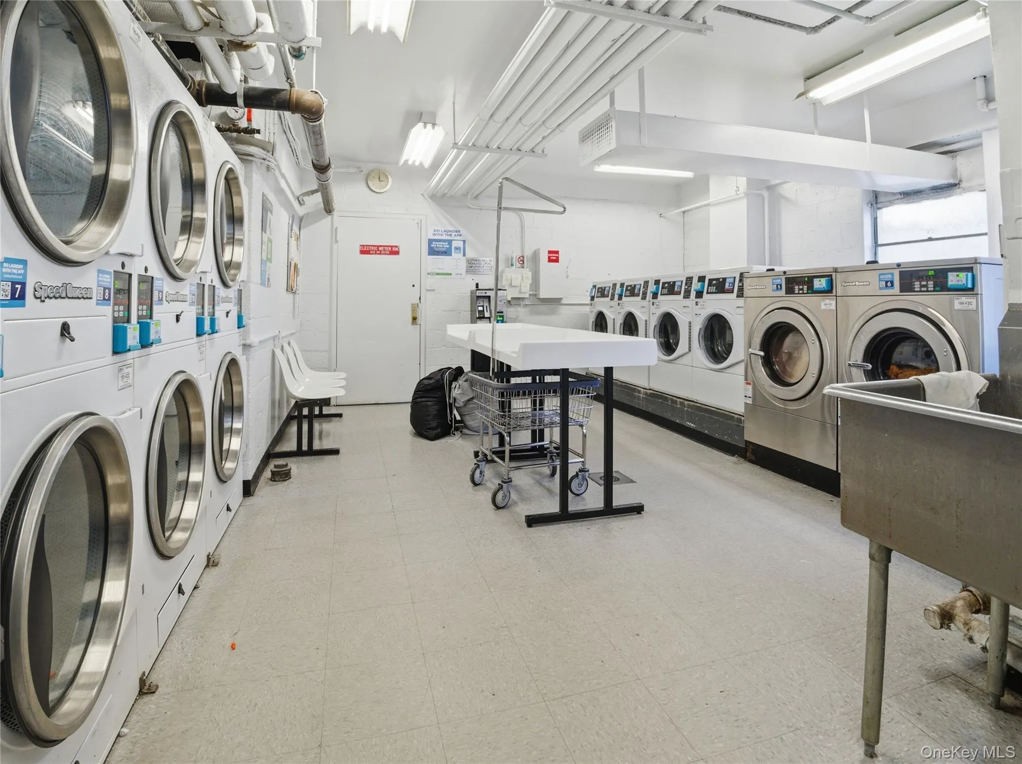 Shared laundry room featuring washing machine and clothes dryer and stacked washer / drying machine Shared laundry room featuring washing machine and clothes dryer and stacked washer / drying machine