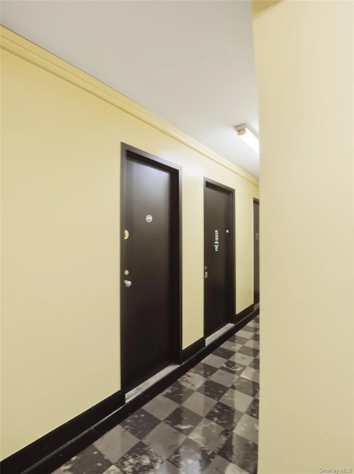 Hallway with dark floors and baseboards Hallway with dark floors and baseboards