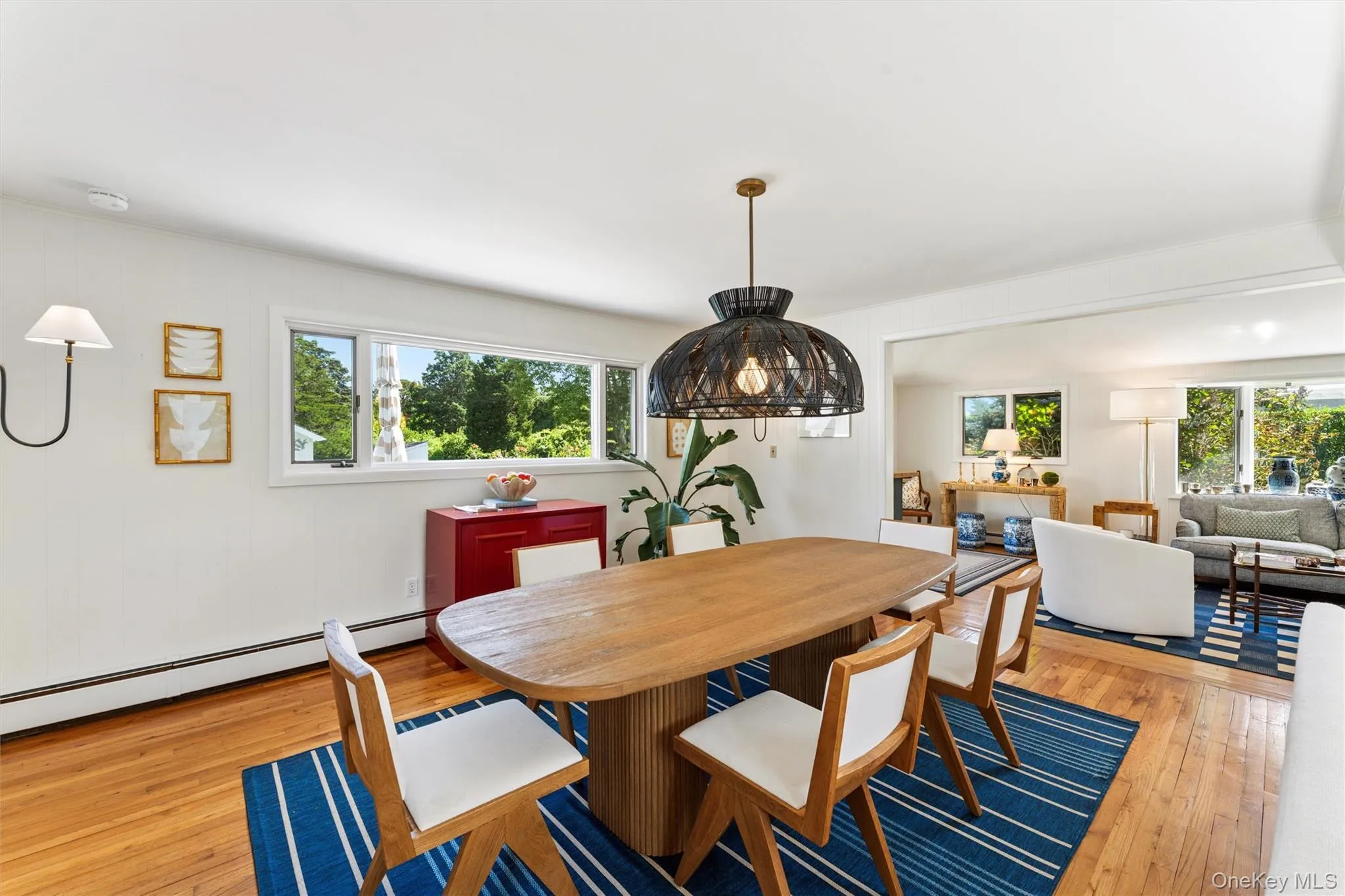 Dining room with light wood finished floors and baseboard heating Dining room with light wood finished floors and baseboard heating