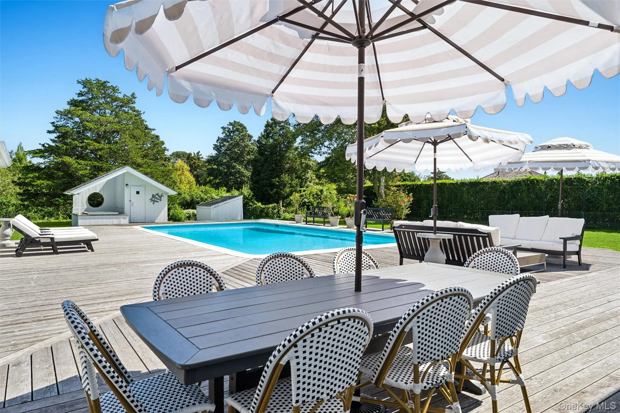 View of pool featuring outdoor dining area, a wooden deck, and an outdoor hangout area View of pool featuring outdoor dining area, a wooden deck, and an outdoor hangout area