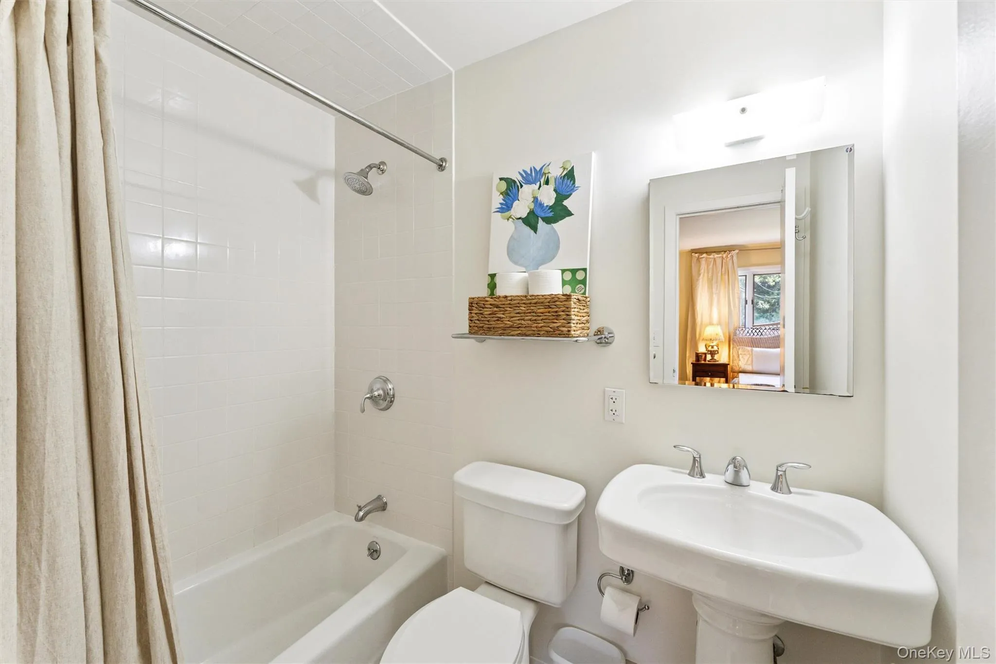 Bathroom featuring shower / bath combo with shower curtain and toilet Bathroom featuring shower / bath combo with shower curtain and toilet