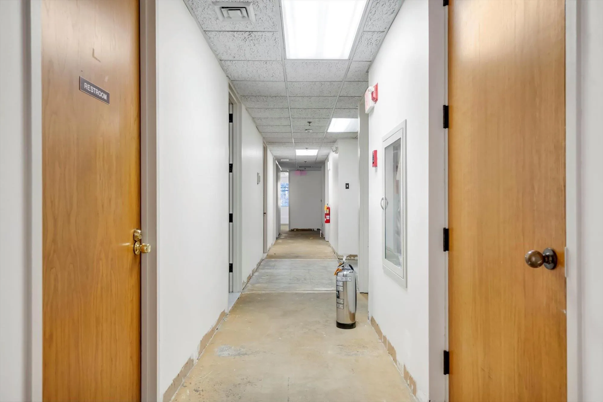 Hallway with a paneled ceiling Hallway with a paneled ceiling