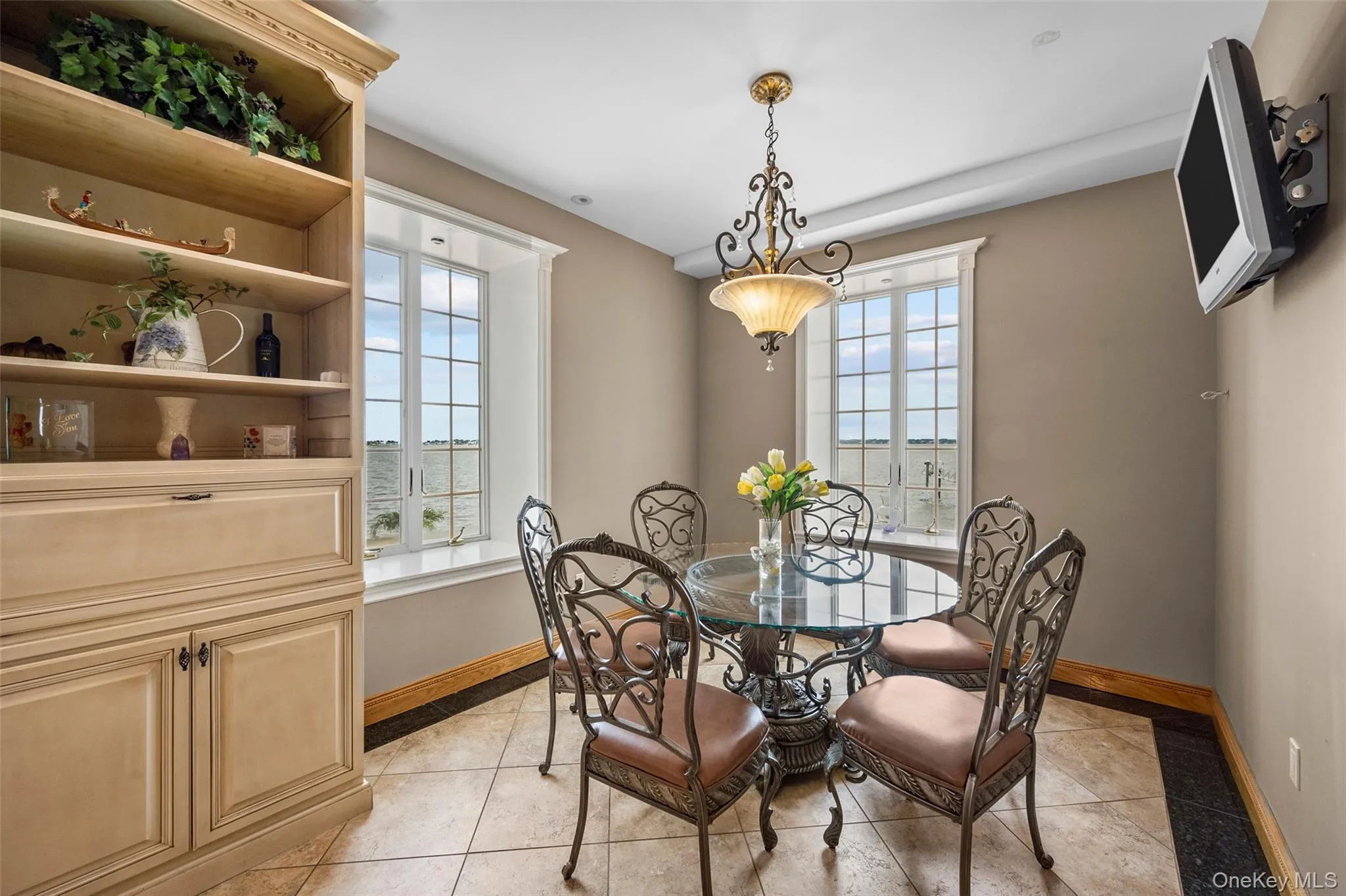 Dining area featuring light tile patterned flooring and baseboards Dining area featuring light tile patterned flooring and baseboards