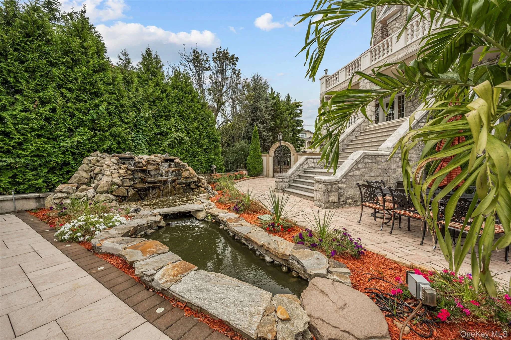 View of yard with stairway, a small pond, and a patio area View of yard with stairway, a small pond, and a patio area