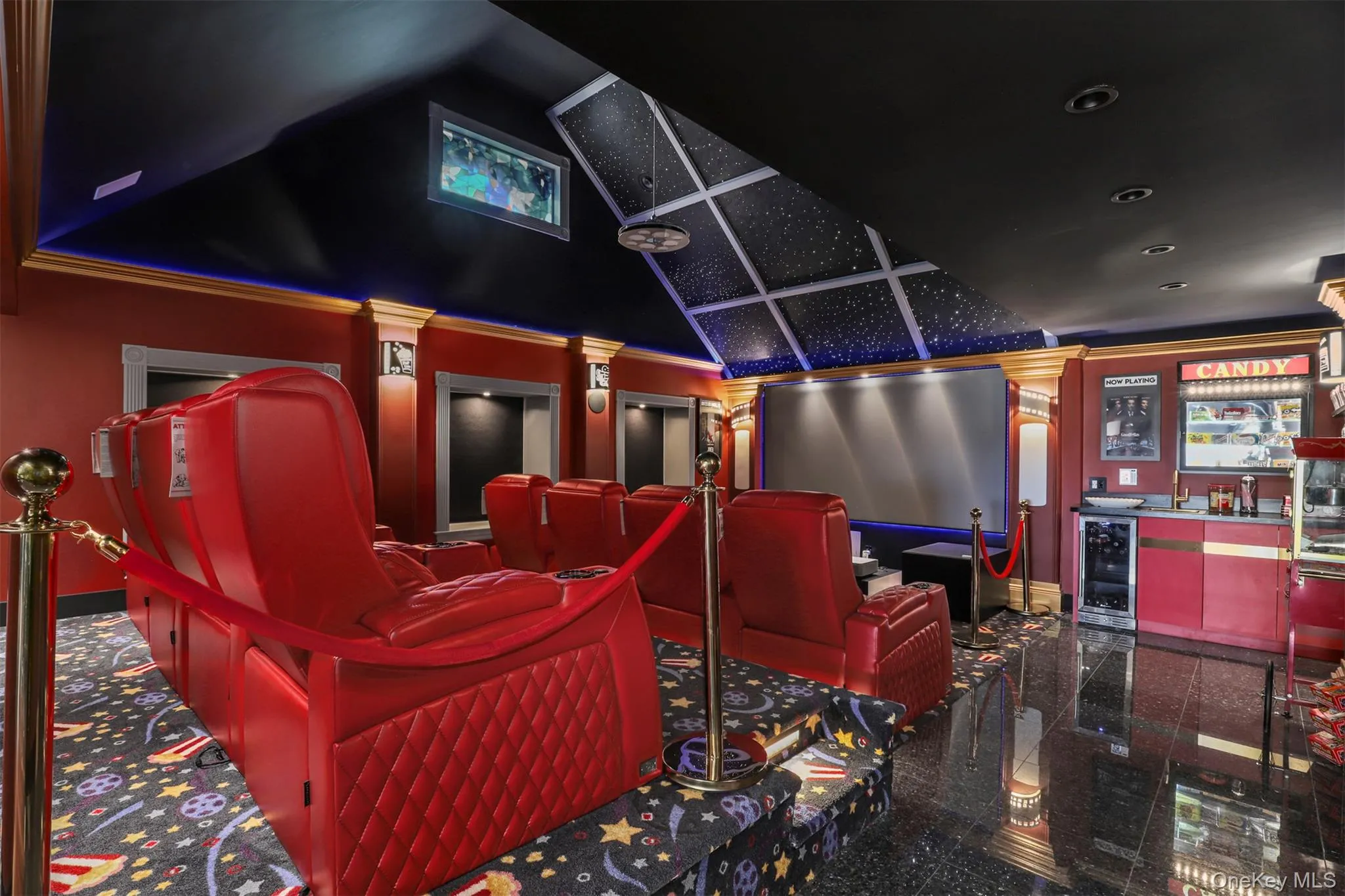 Home theater room featuring granite finish floor, recessed lighting, decorative columns, wine cooler, and a community bar Home theater room featuring granite finish floor, recessed lighting, decorative columns, wine cooler, and a community bar