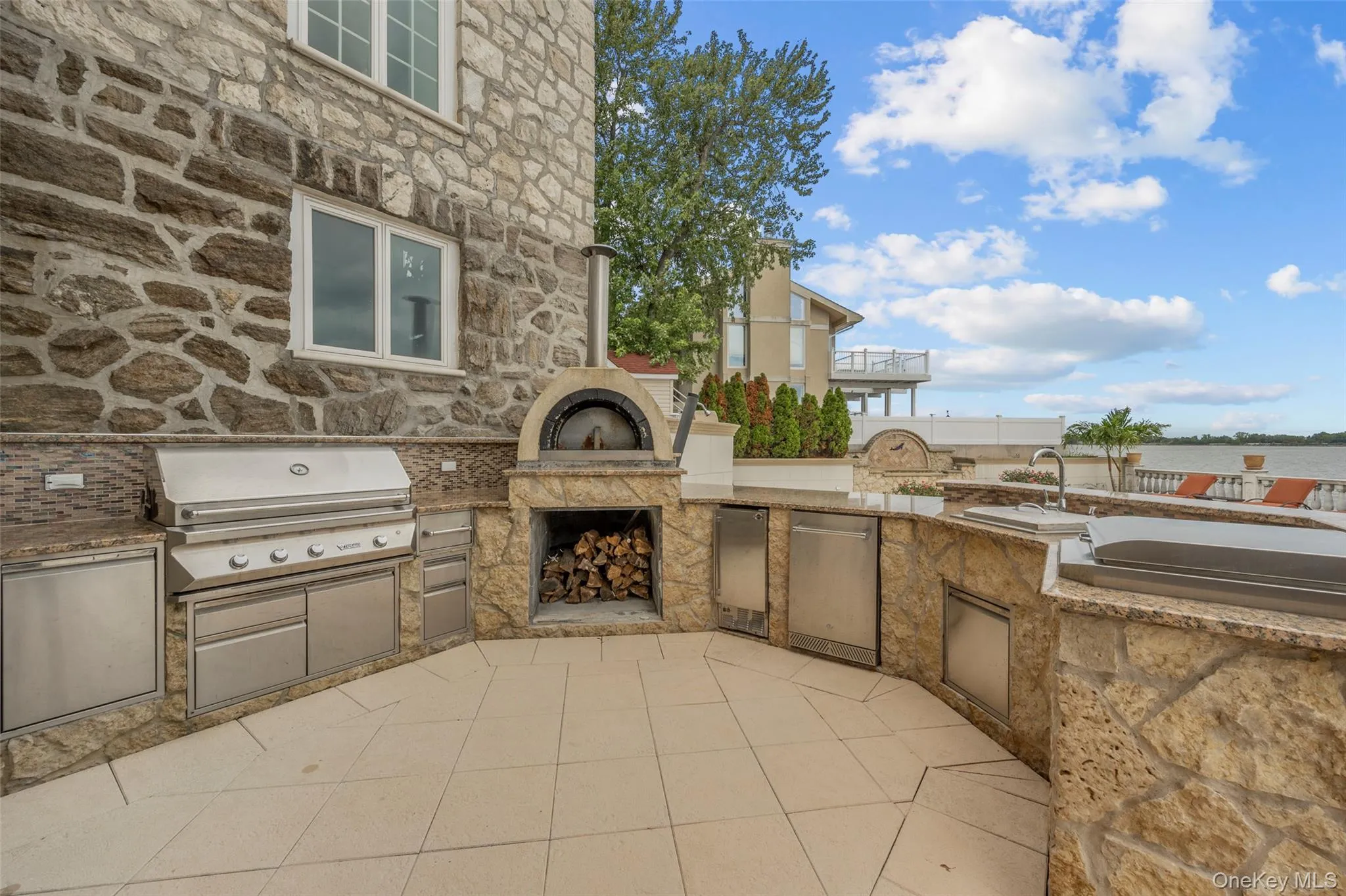 View of patio with exterior fireplace, area for grilling, and exterior kitchen View of patio with exterior fireplace, area for grilling, and exterior kitchen
