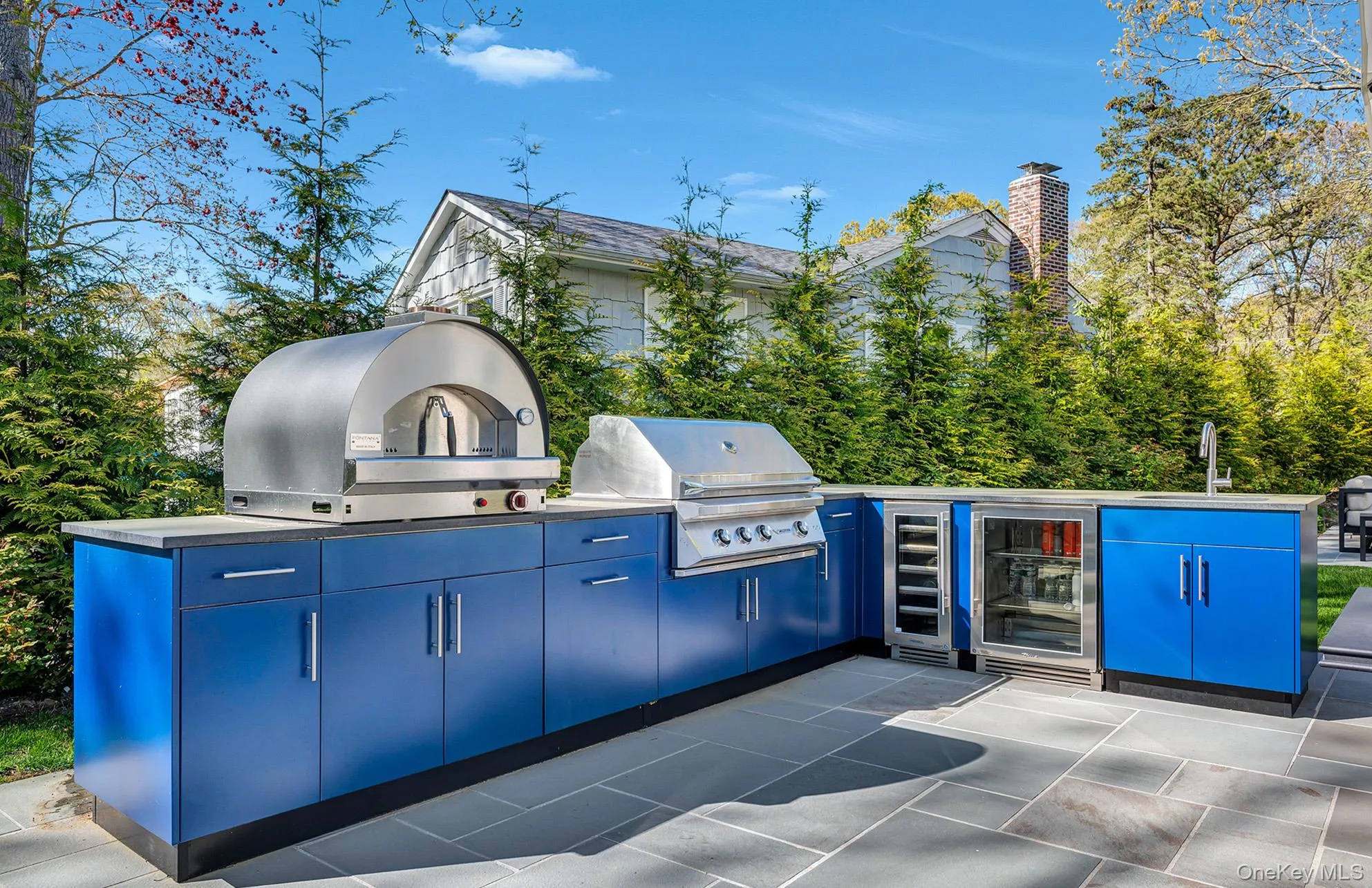 View of patio with wine cooler, a grill, sink, and exterior kitchen View of patio with wine cooler, a grill, sink, and exterior kitchen