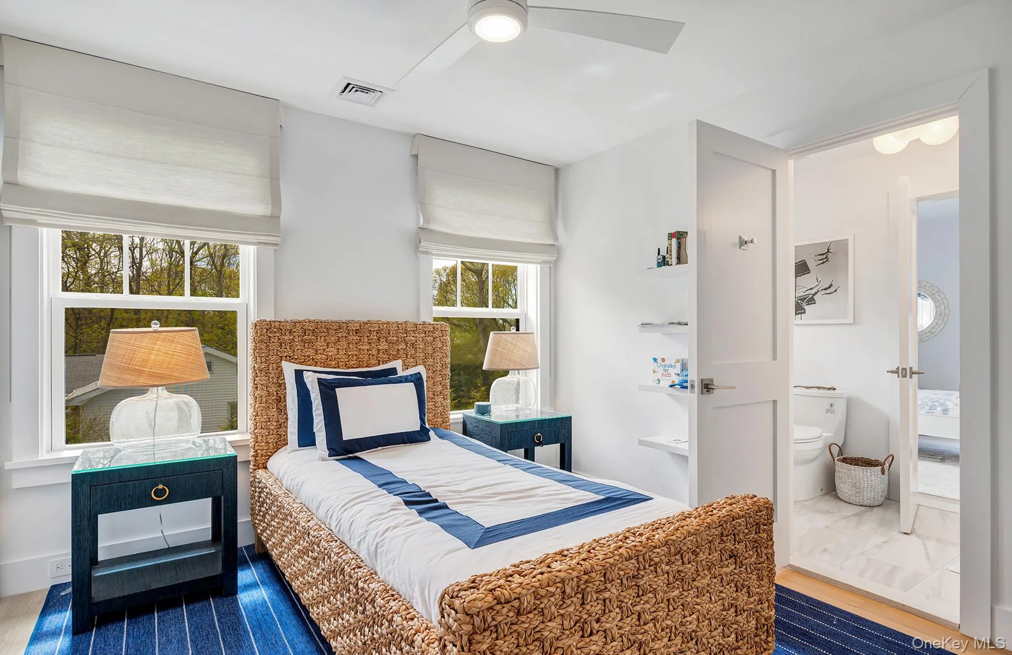 Bedroom with multiple windows, hardwood / wood-style flooring, ceiling fan, and ensuite bath Bedroom with multiple windows, hardwood / wood-style flooring, ceiling fan, and ensuite bath