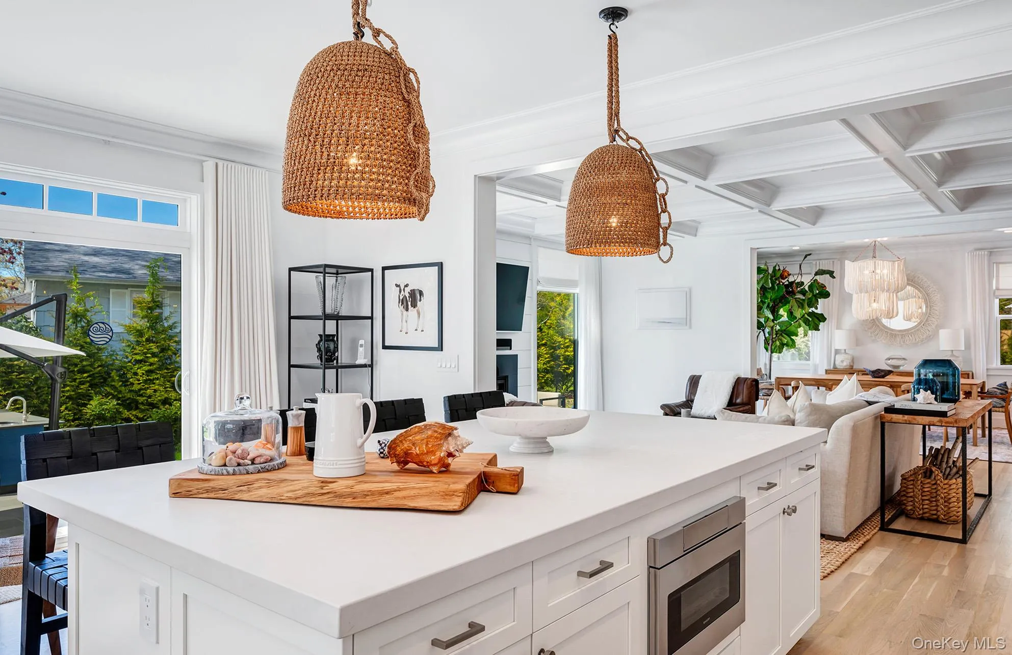 Kitchen with stainless steel microwave, coffered ceiling, a wealth of natural light, white cabinets, and beamed ceiling Kitchen with stainless steel microwave, coffered ceiling, a wealth of natural light, white cabinets, and beamed ceiling
