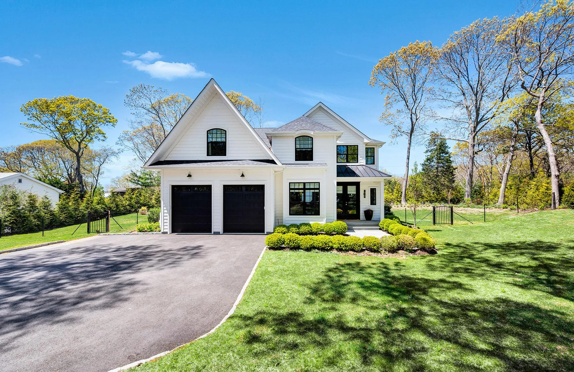 View of front of property with a porch, a garage, and a front yard View of front of property with a porch, a garage, and a front yard
