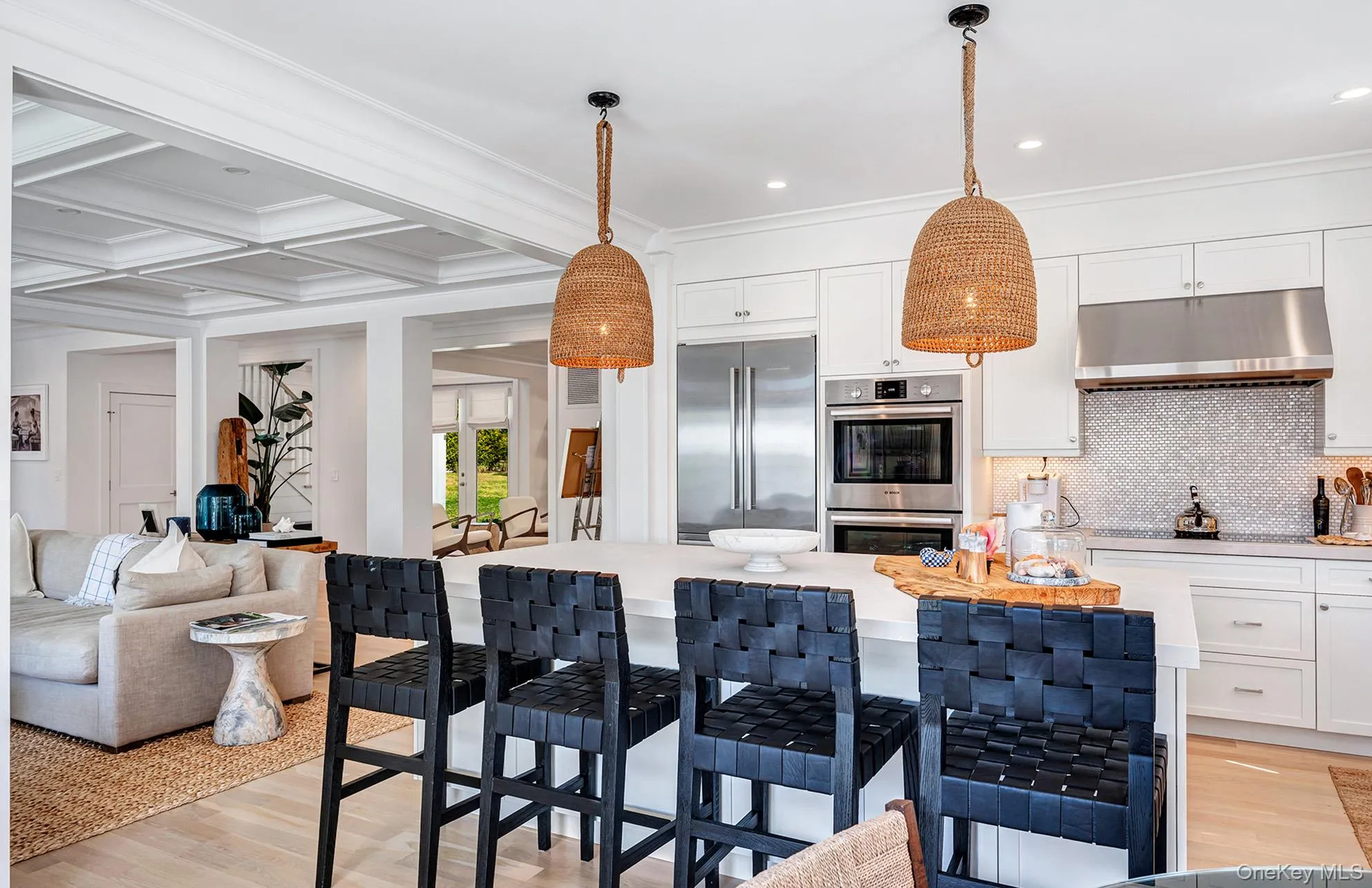 Kitchen with coffered ceiling, decorative light fixtures, beamed ceiling, stainless steel appliances, and white cabinets Kitchen with coffered ceiling, decorative light fixtures, beamed ceiling, stainless steel appliances, and white cabinets