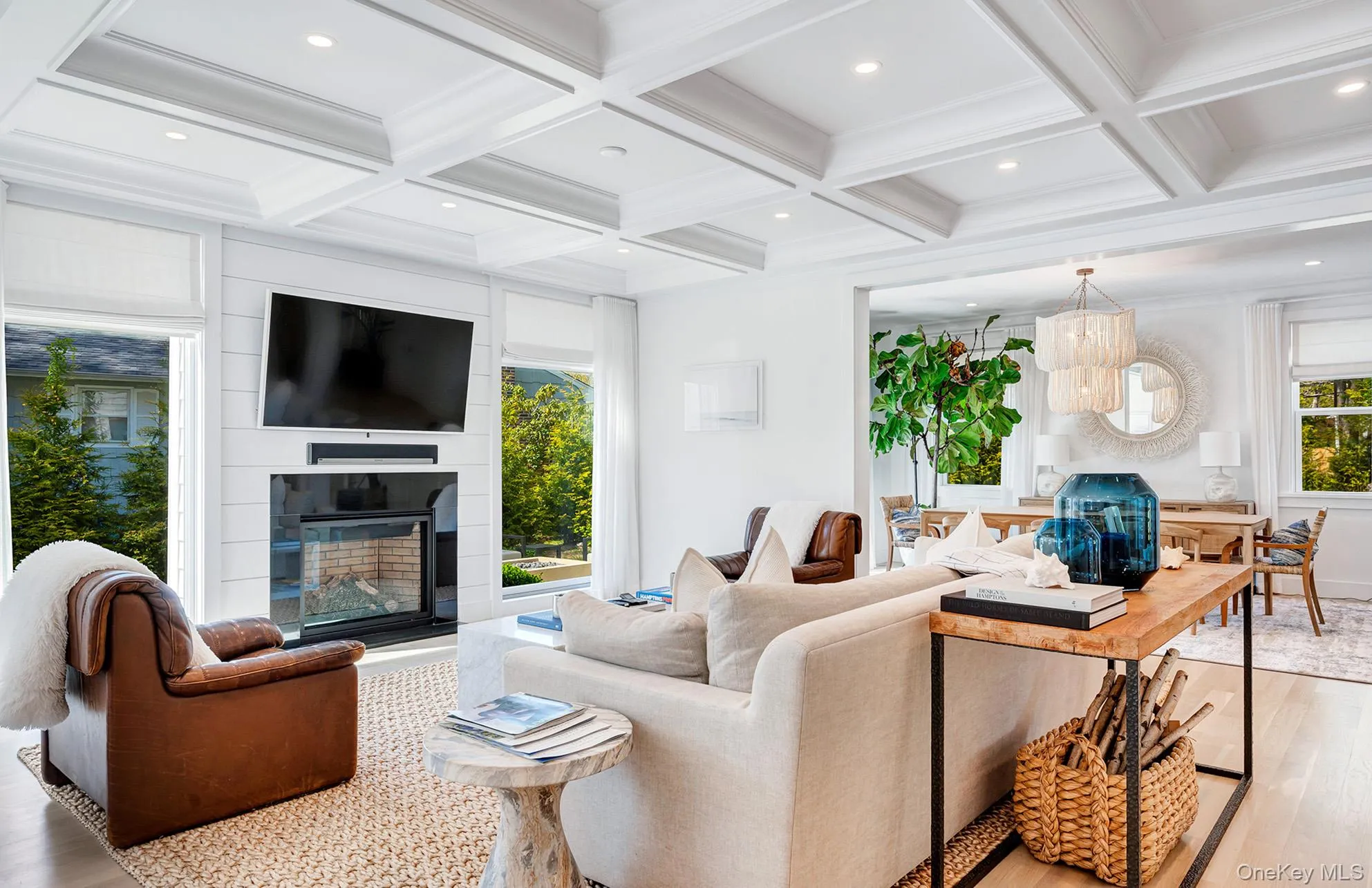 Living room featuring a healthy amount of sunlight, a fireplace, and beam ceiling Living room featuring a healthy amount of sunlight, a fireplace, and beam ceiling