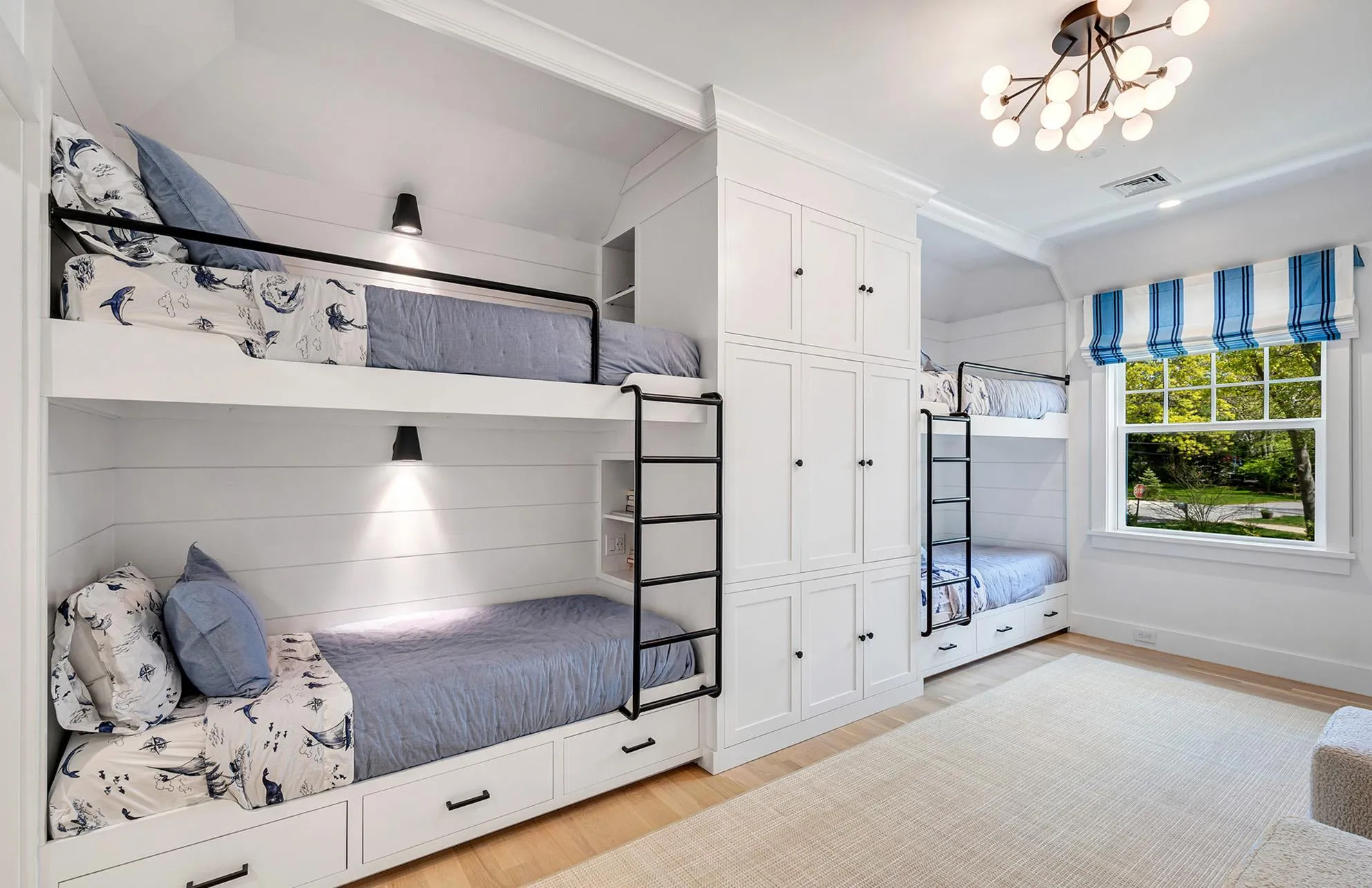 Bedroom featuring ornamental molding, light hardwood / wood-style floors, a closet, and a notable chandelier Bedroom featuring ornamental molding, light hardwood / wood-style floors, a closet, and a notable chandelier
