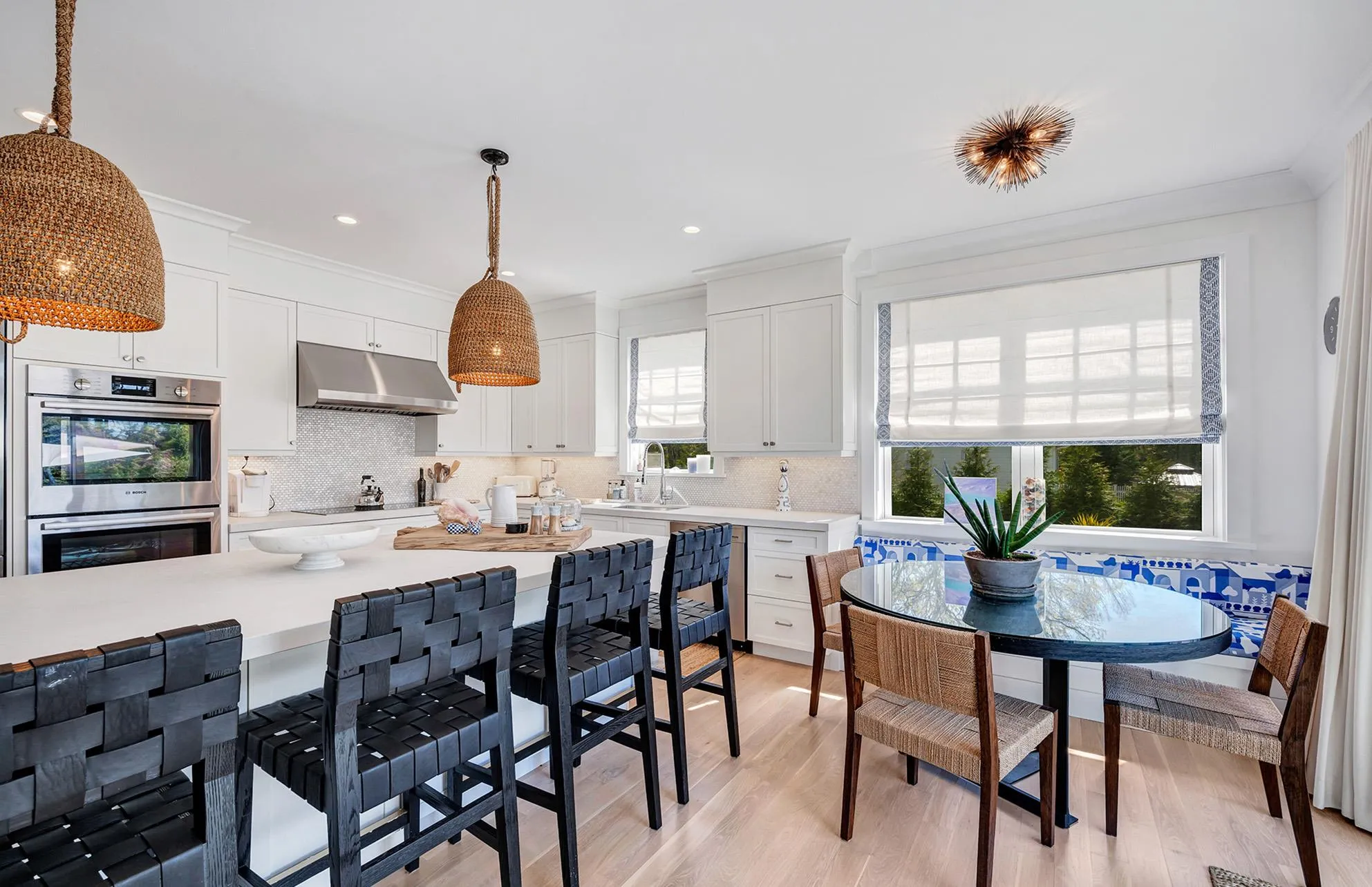 Kitchen featuring pendant lighting, white cabinetry, sink, and double oven Kitchen featuring pendant lighting, white cabinetry, sink, and double oven