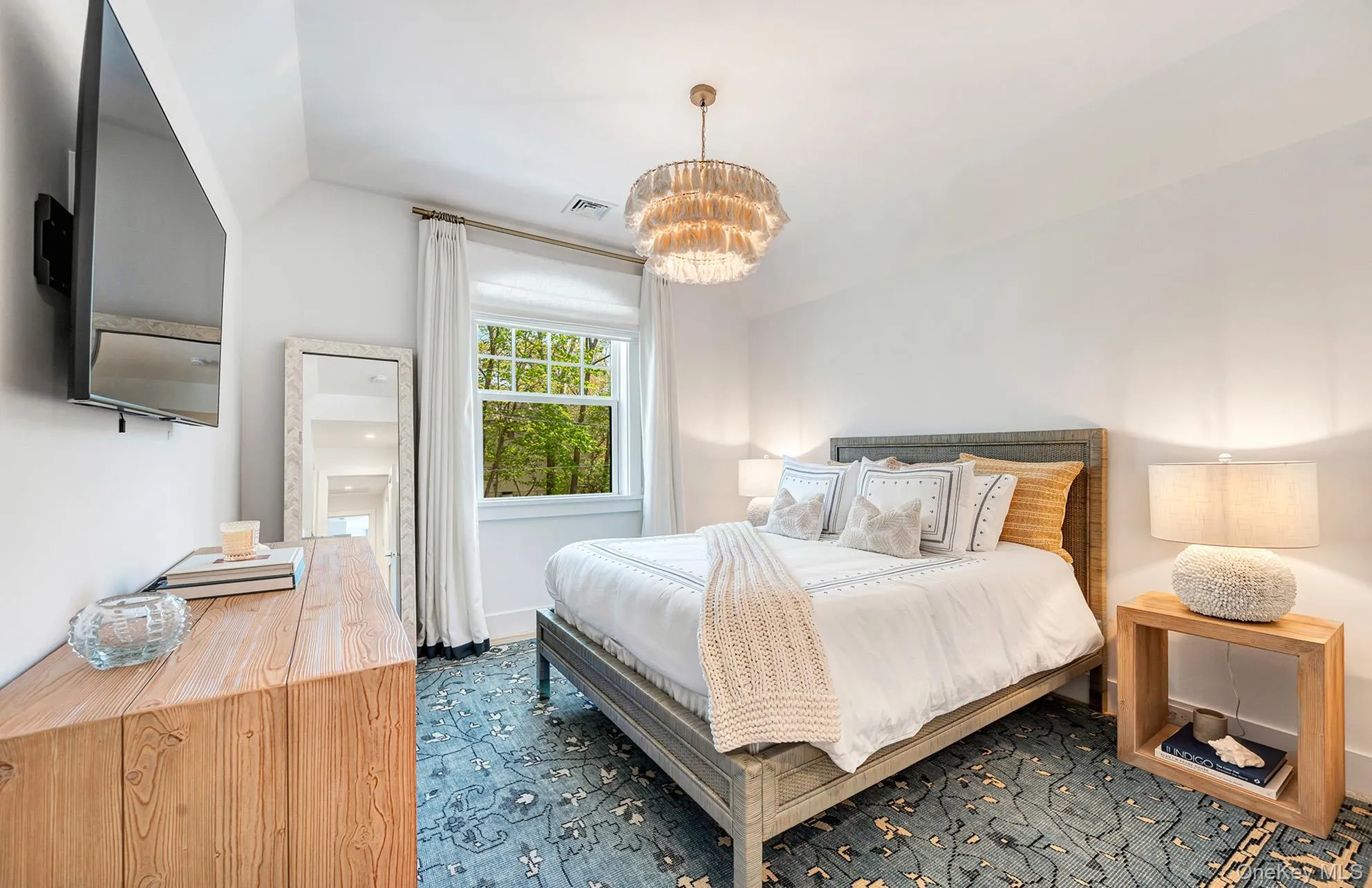 Bedroom featuring vaulted ceiling and a chandelier Bedroom featuring vaulted ceiling and a chandelier