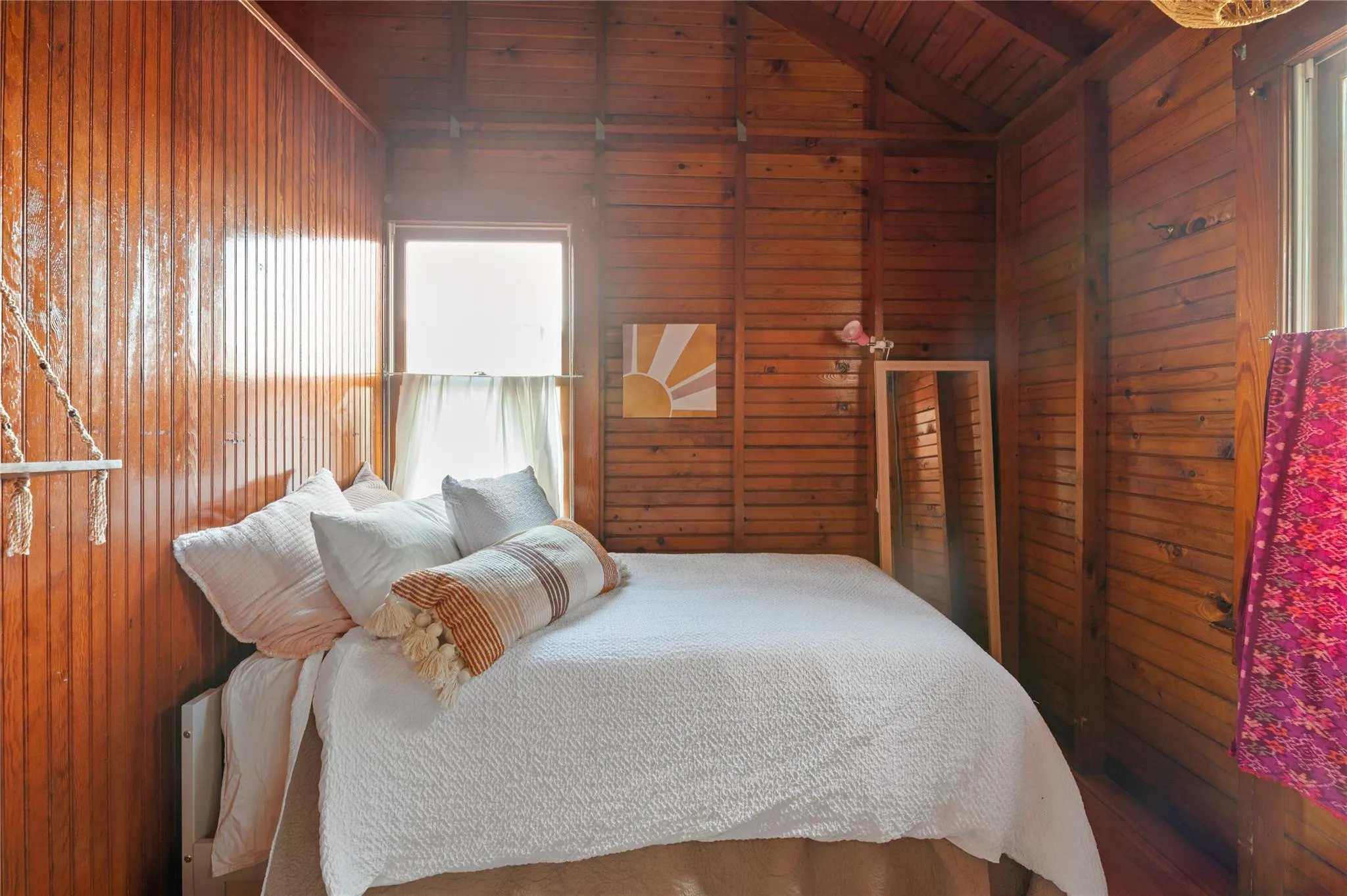 Bedroom featuring wood ceiling, wooden walls, and lofted ceiling with beams Bedroom featuring wood ceiling, wooden walls, and lofted ceiling with beams