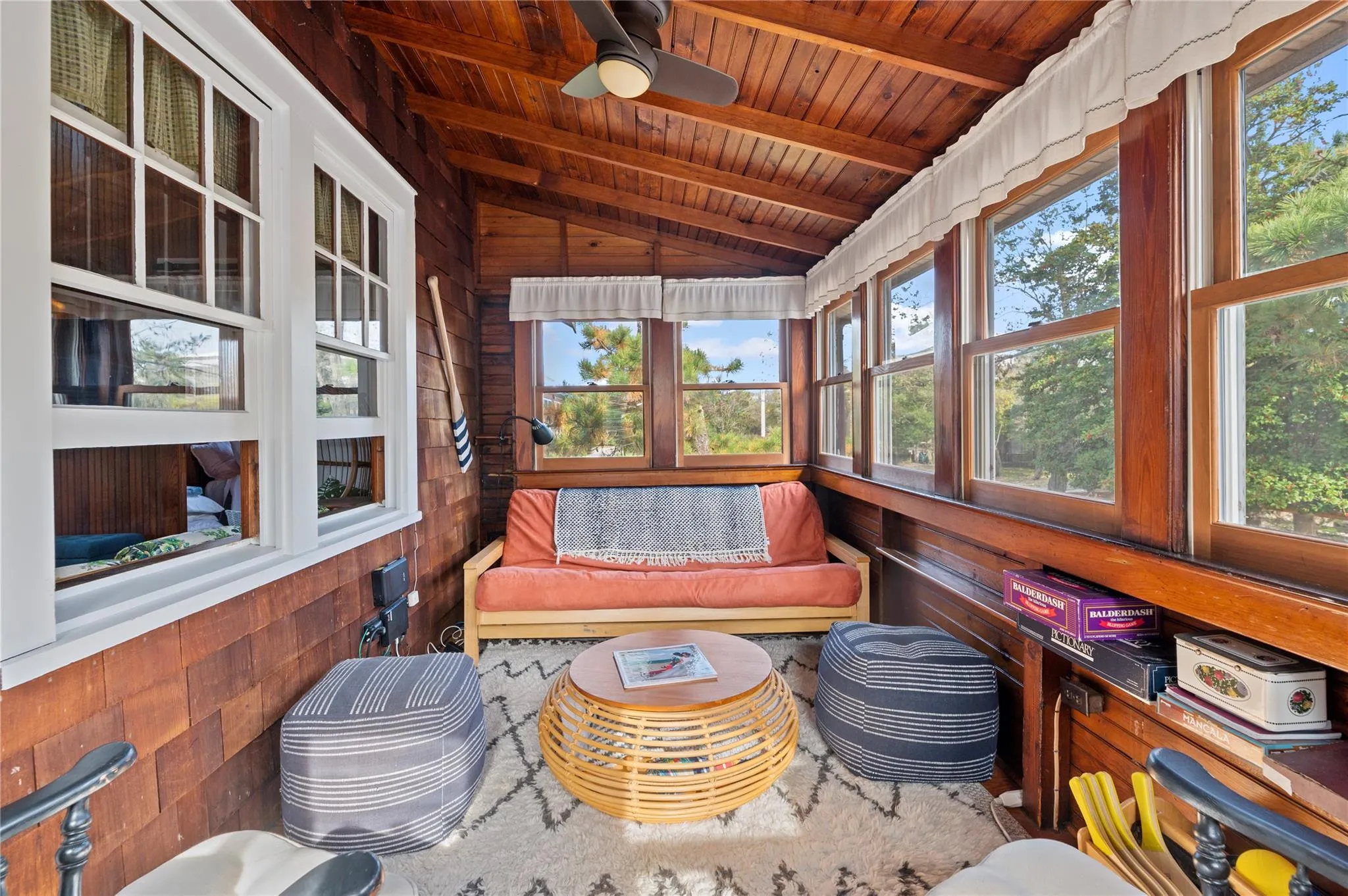 Sunroom / solarium featuring lofted ceiling with beams, wooden ceiling, and ceiling fan Sunroom / solarium featuring lofted ceiling with beams, wooden ceiling, and ceiling fan