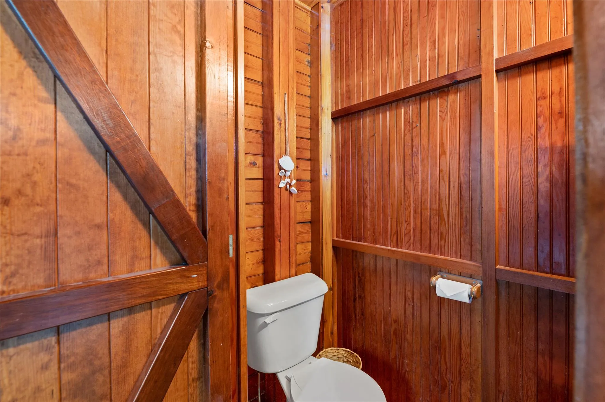 Bathroom with wooden walls and toilet Bathroom with wooden walls and toilet