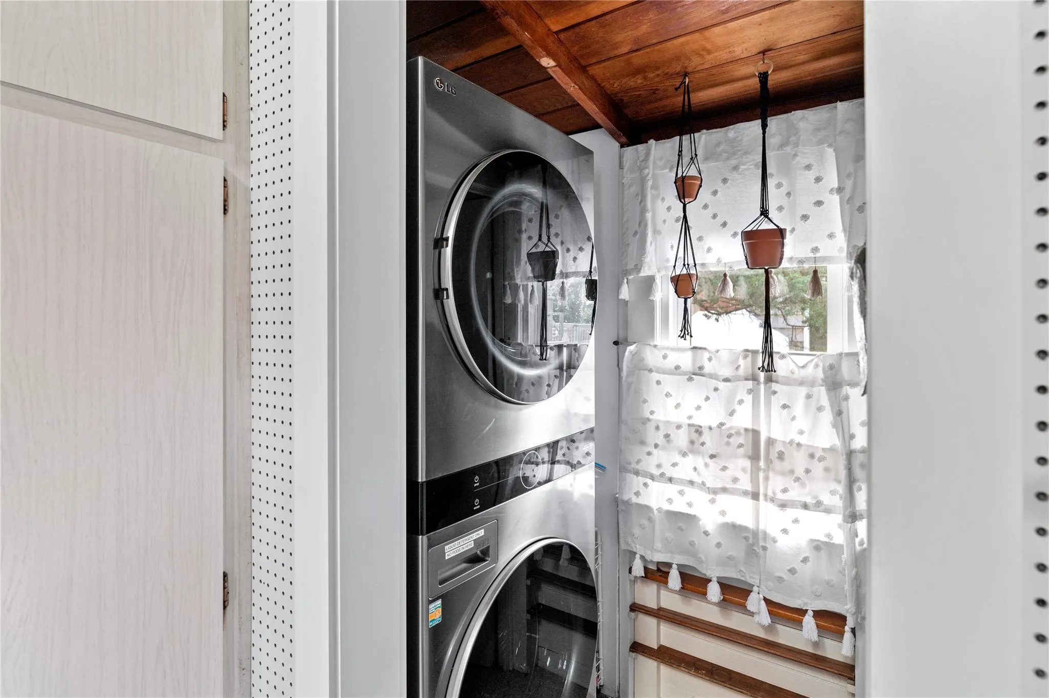Clothes washing area featuring stacked washer and clothes dryer Clothes washing area featuring stacked washer and clothes dryer