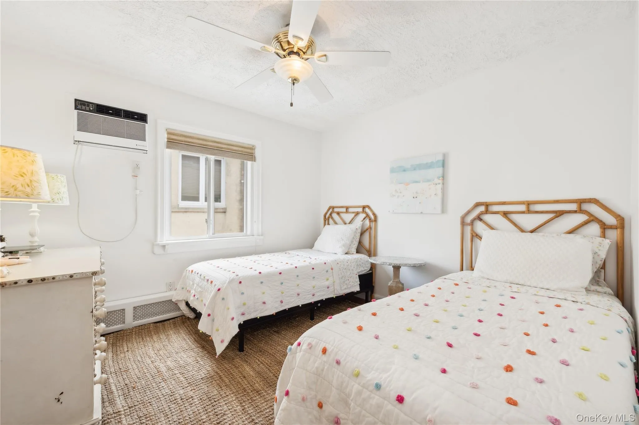 Bedroom with a textured ceiling, a wall unit AC, and ceiling fan Bedroom with a textured ceiling, a wall unit AC, and ceiling fan