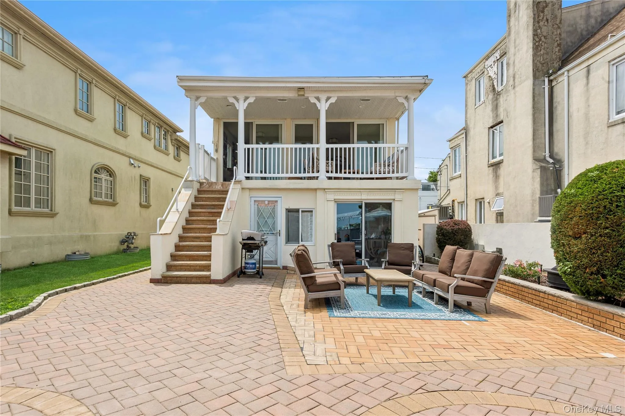 Back of property featuring a balcony, an outdoor living space, and a patio area Back of property featuring a balcony, an outdoor living space, and a patio area