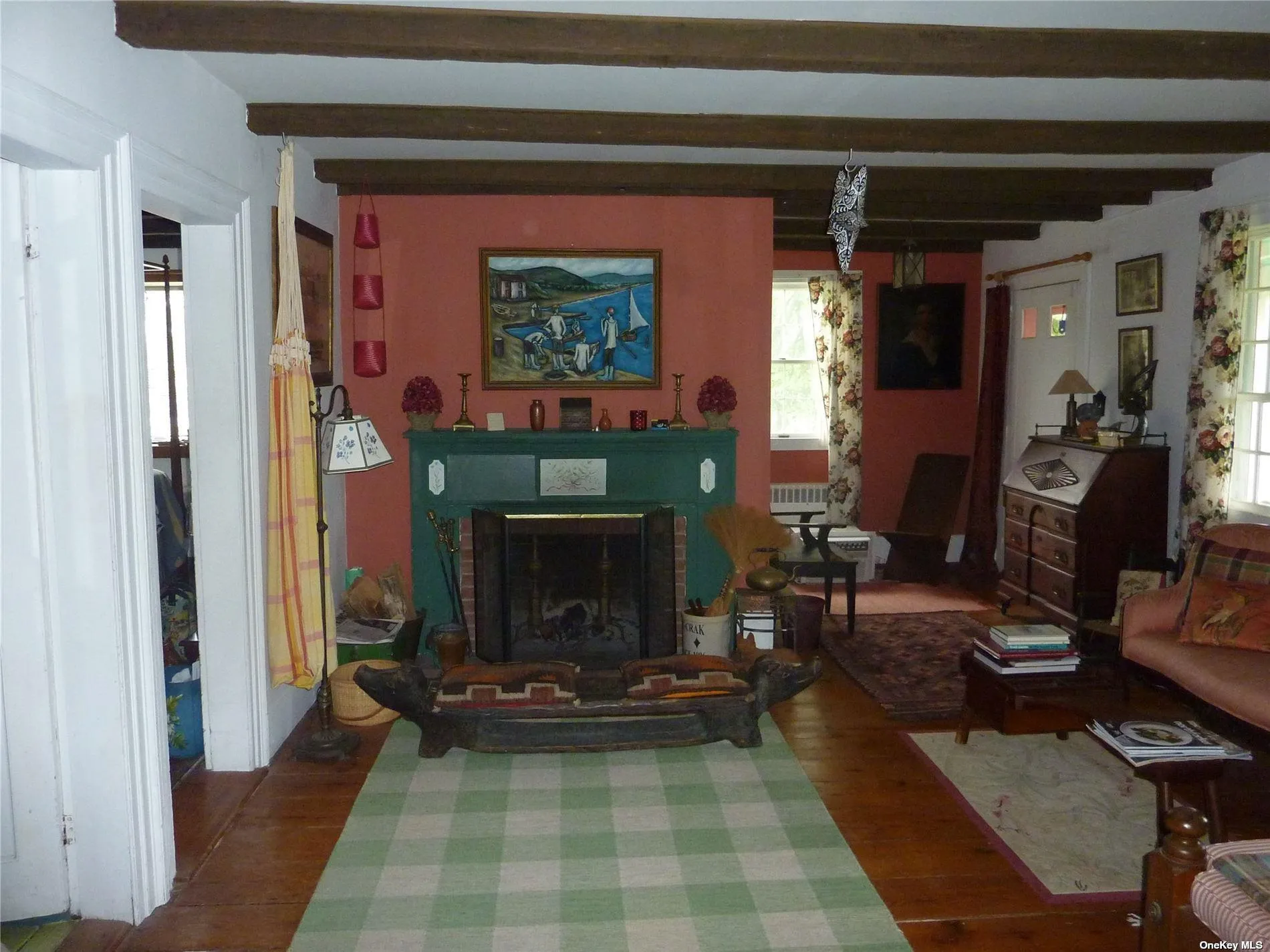 Living room with hardwood / wood-style flooring and beam ceiling Living room with hardwood / wood-style flooring and beam ceiling