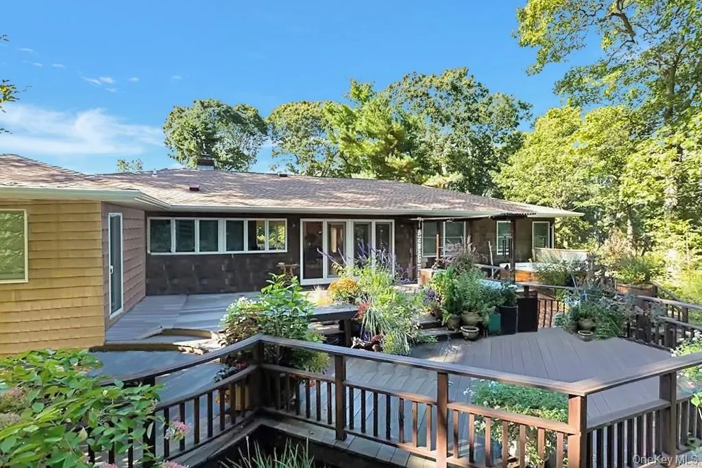 Rear view of property featuring a wooden deck Rear view of property featuring a wooden deck