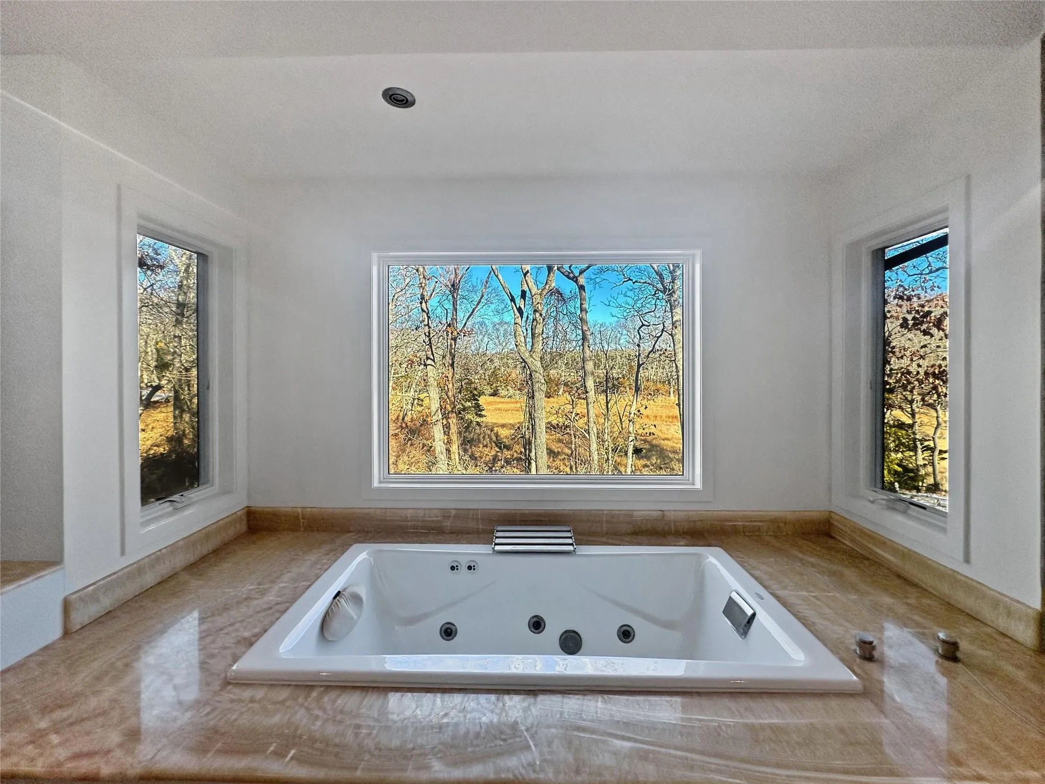 Bathroom featuring tiled bath Bathroom featuring tiled bath