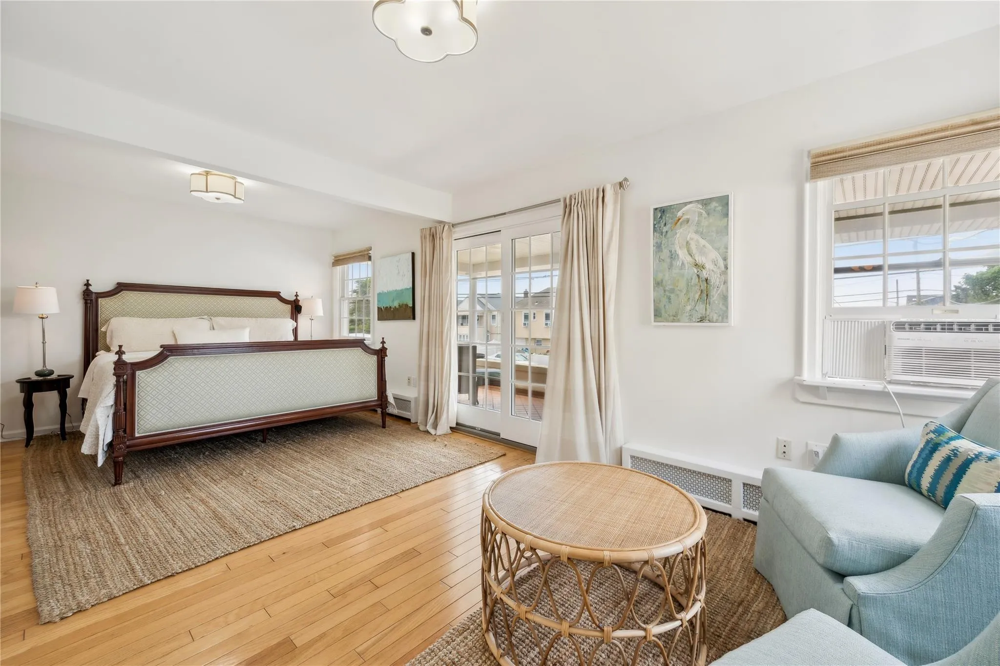 Bedroom featuring cooling unit and hardwood / wood-style floors Bedroom featuring cooling unit and hardwood / wood-style floors