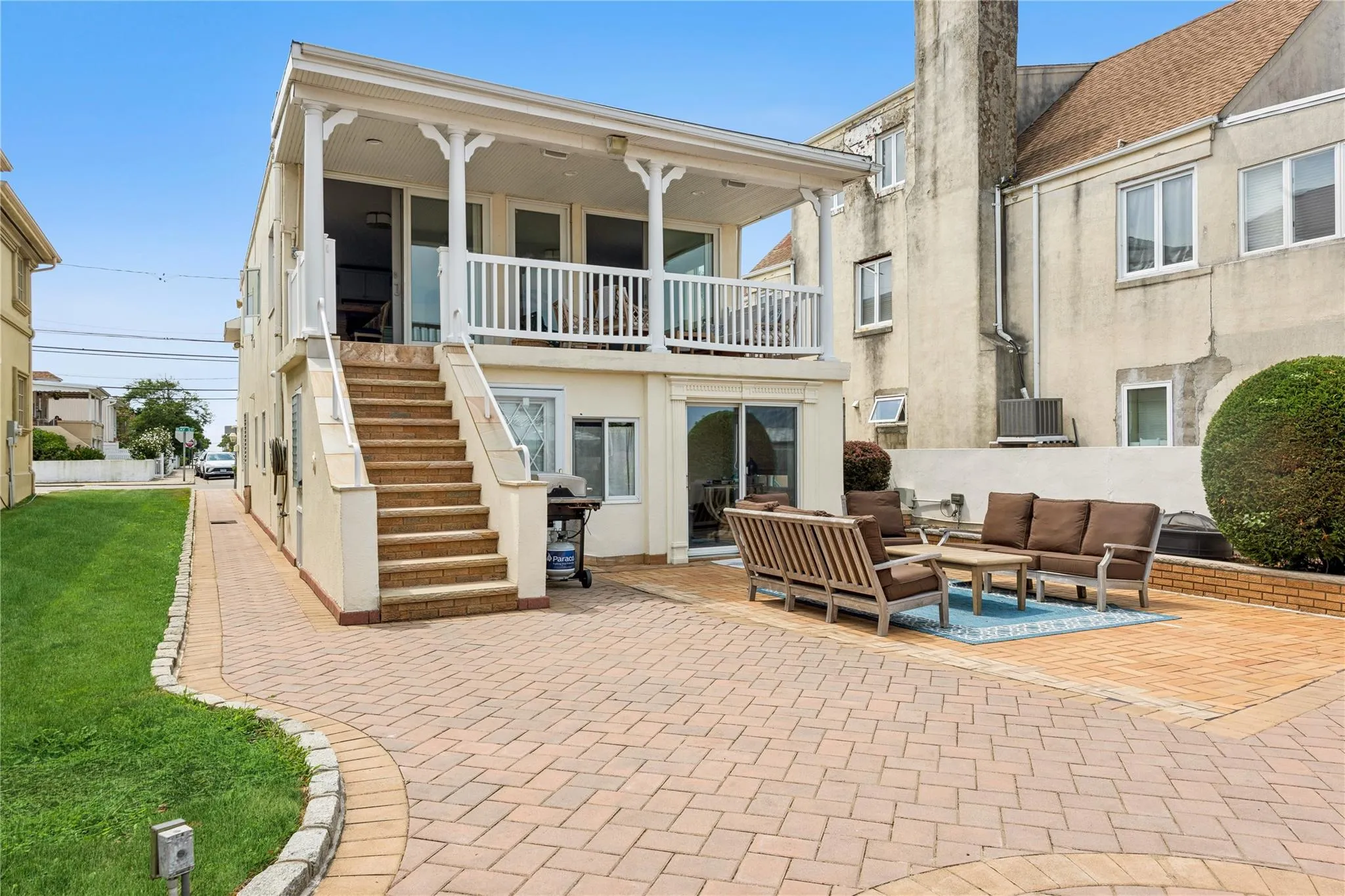 Rear view of property featuring a balcony, an outdoor living space, and a patio area Rear view of property featuring a balcony, an outdoor living space, and a patio area