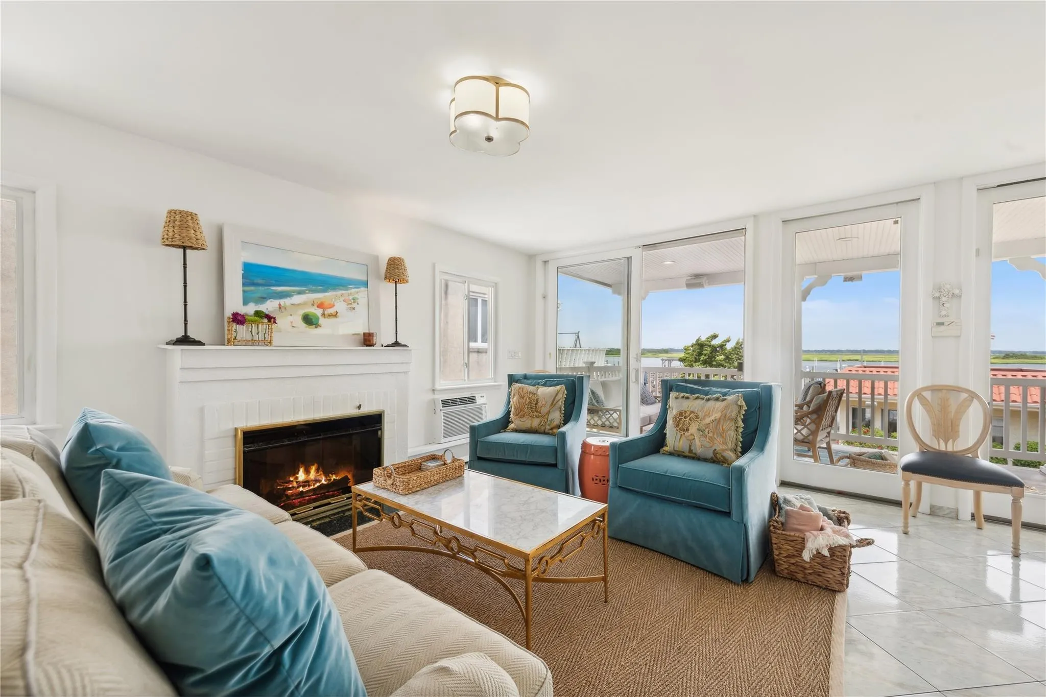 Tiled living room featuring a brick fireplace, a wall of windows, and a wall unit AC Tiled living room featuring a brick fireplace, a wall of windows, and a wall unit AC